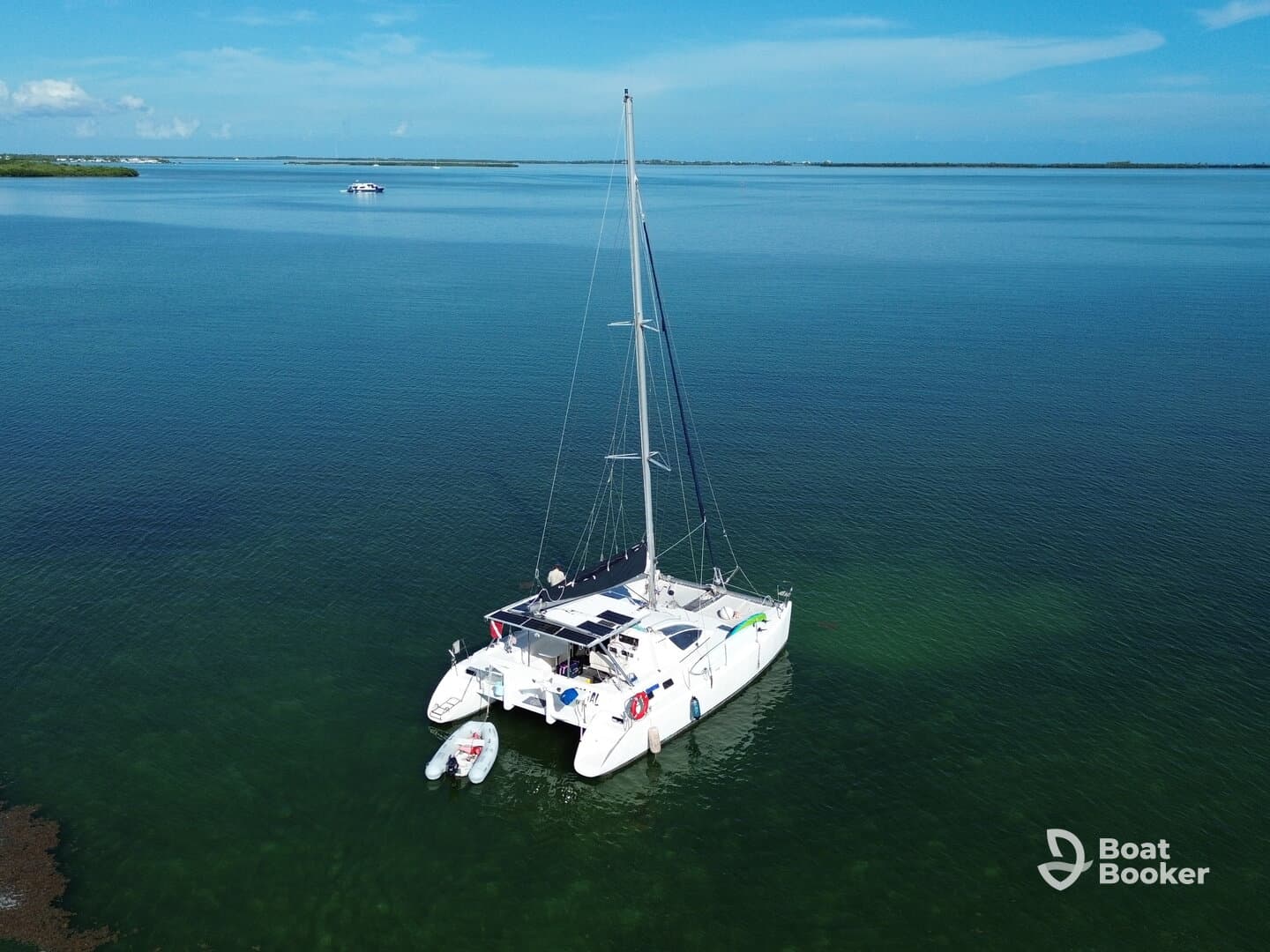 Aerial view of a catamaran anchored in calm waters, showcasing its sleek design and tranquil surroundings — perfect for serene sailing adventures.