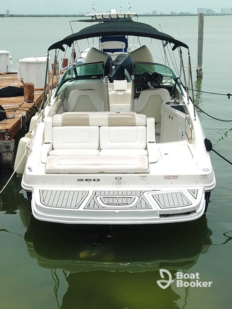 A sleek speedboat docked at the marina, showcasing its stylish design and spacious seating — perfect for a day on the water.