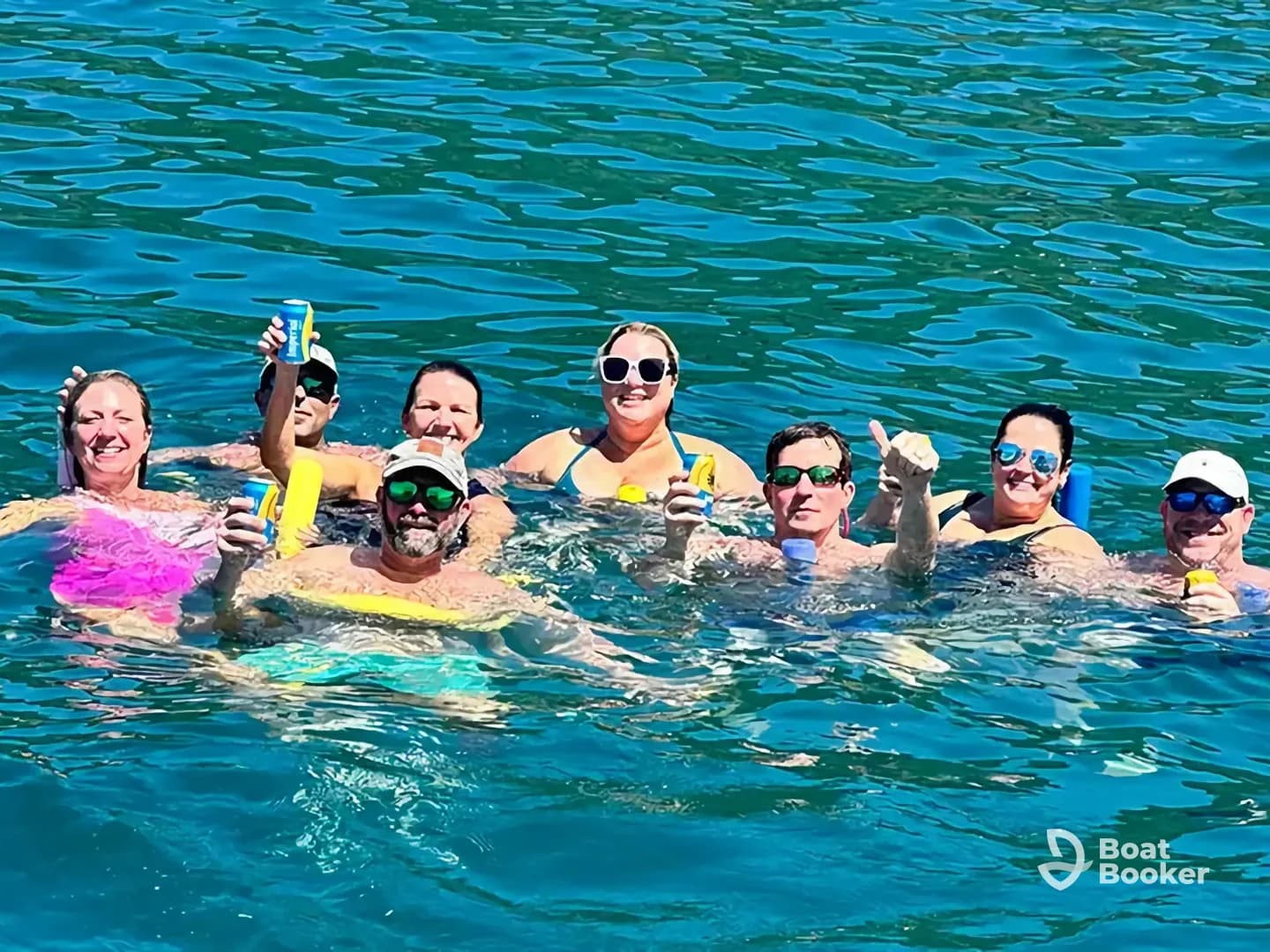 A lively group enjoys a fun day in the water, celebrating with drinks and smiles — perfect for summer outings and memorable gatherings.