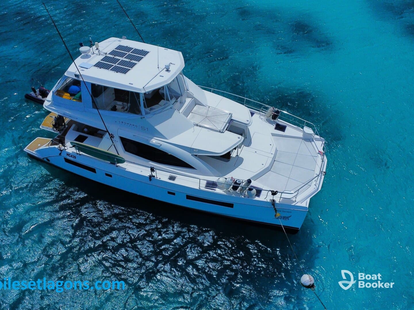 A stunning aerial view of a Leopard 51 catamaran cruising through crystal-clear waters, perfect for luxury charters and island adventures.