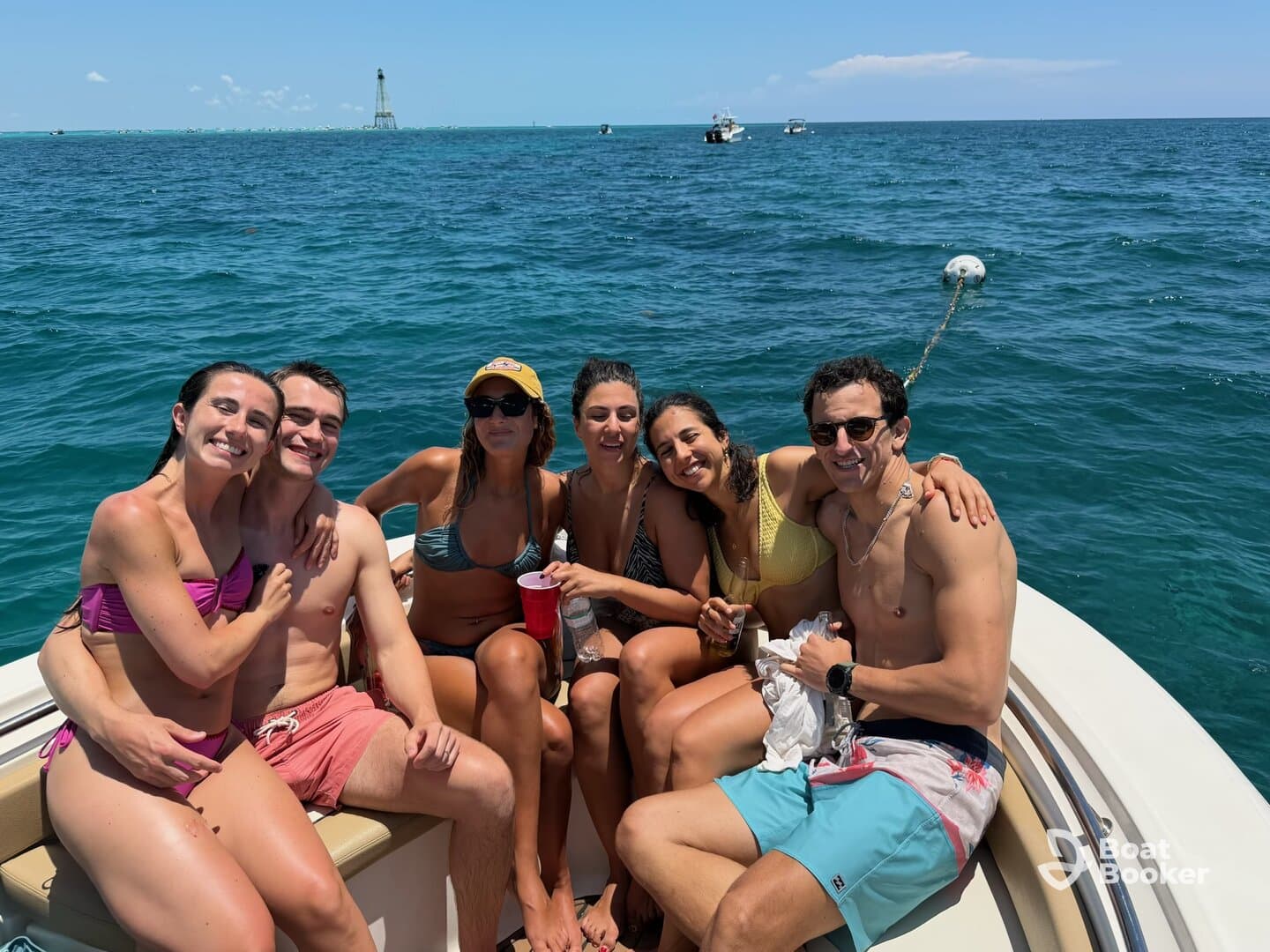A lively group of friends enjoys a sunny day on the water, celebrating together aboard a boat — perfect for summer outings and memorable adventures.