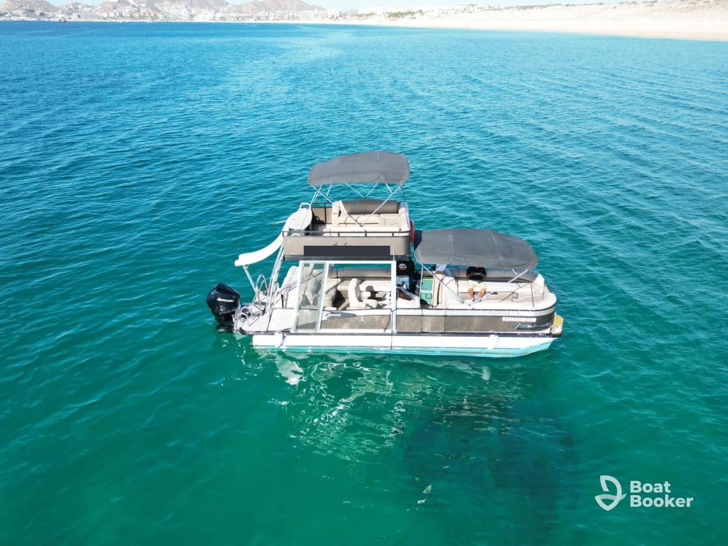 Aerial view of a stylish pontoon boat cruising through crystal-clear turquoise waters, perfect for leisurely outings and family adventures.