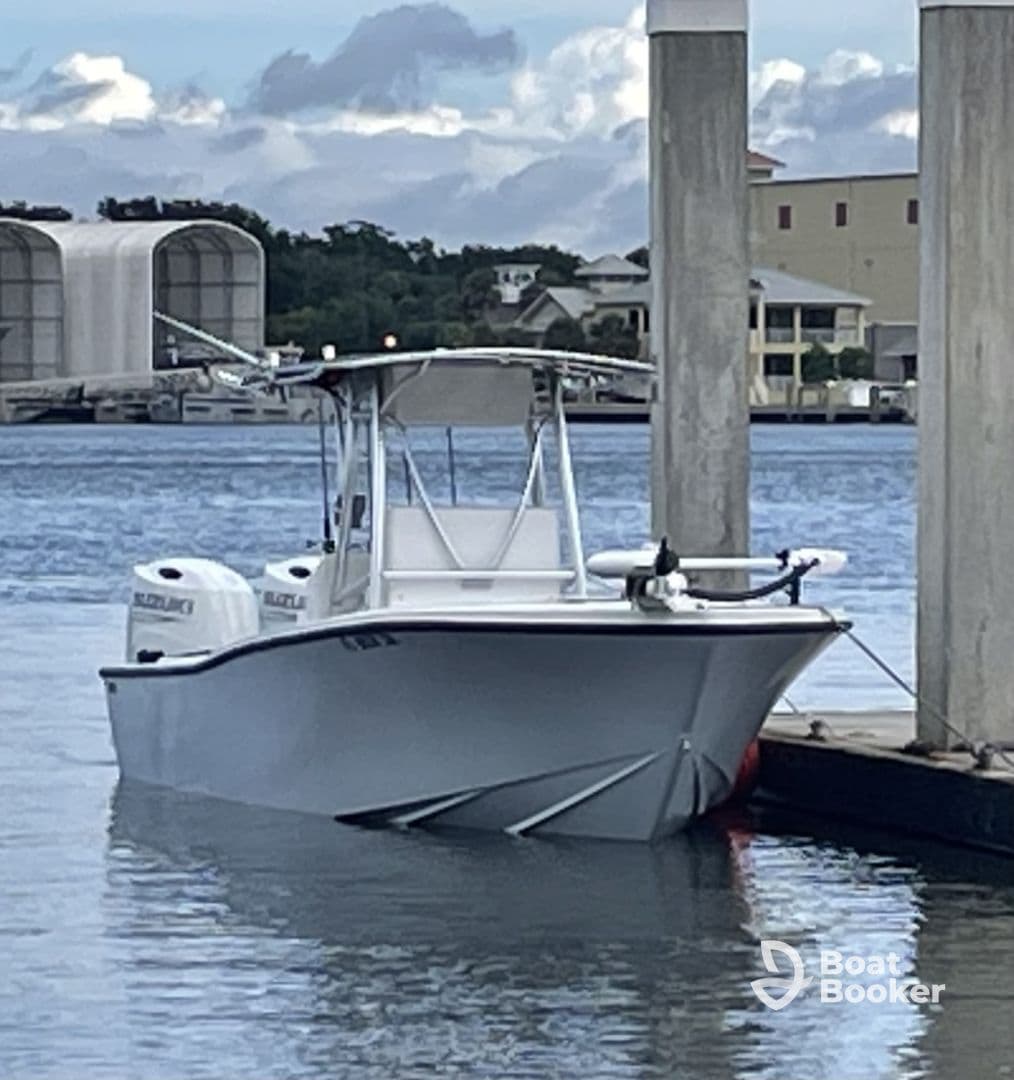 A sleek center console boat docked at the marina, showcasing its modern design and readiness for fishing or leisure activities.