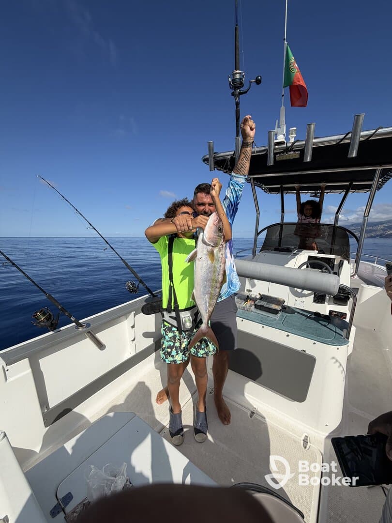 A joyful family celebrates their fishing catch aboard a boat, showcasing a successful day on the water. Perfect for family fishing adventures and memorable moments.