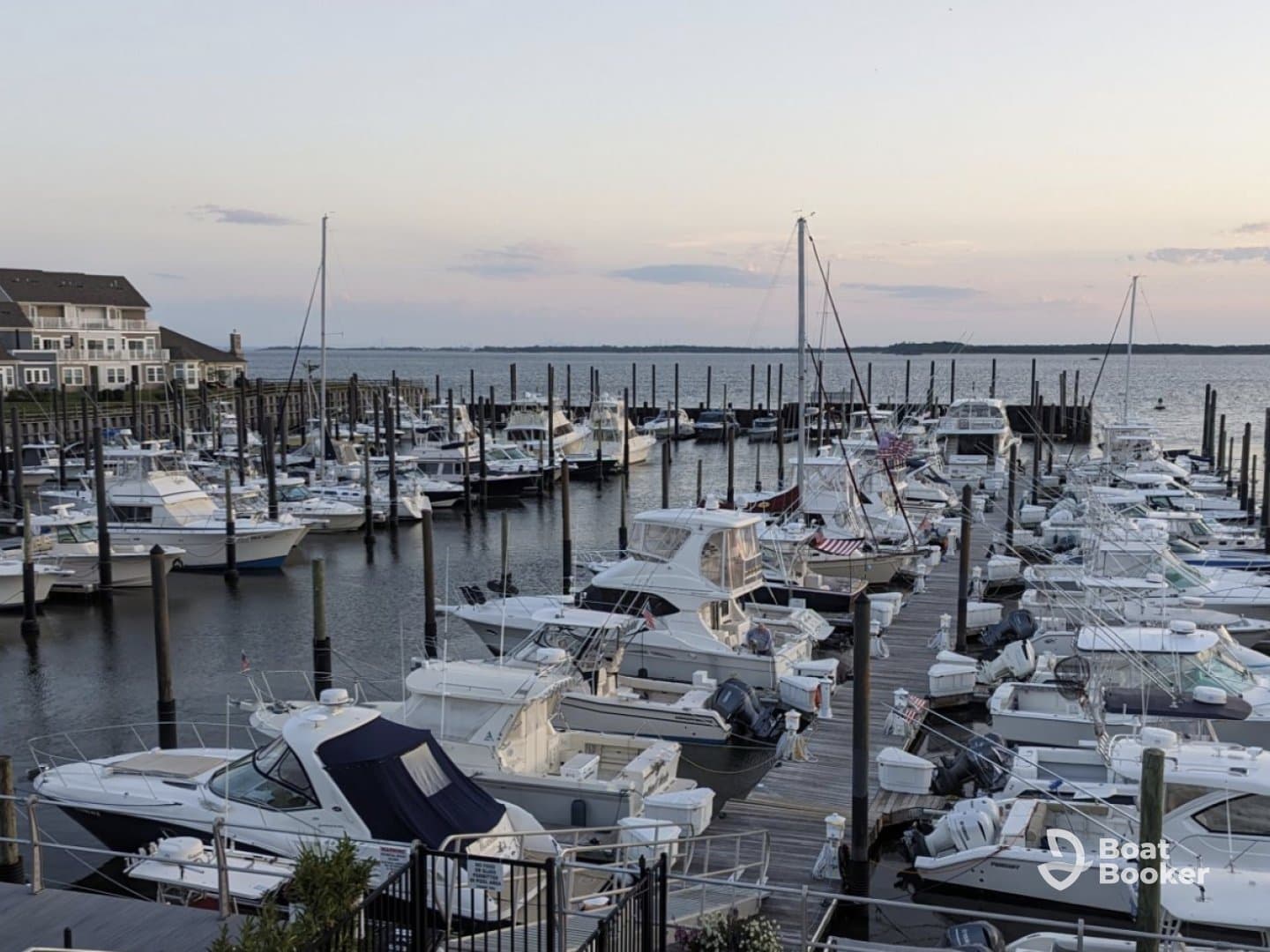 A picturesque marina filled with various boats docked at sunset, showcasing a vibrant boating community.