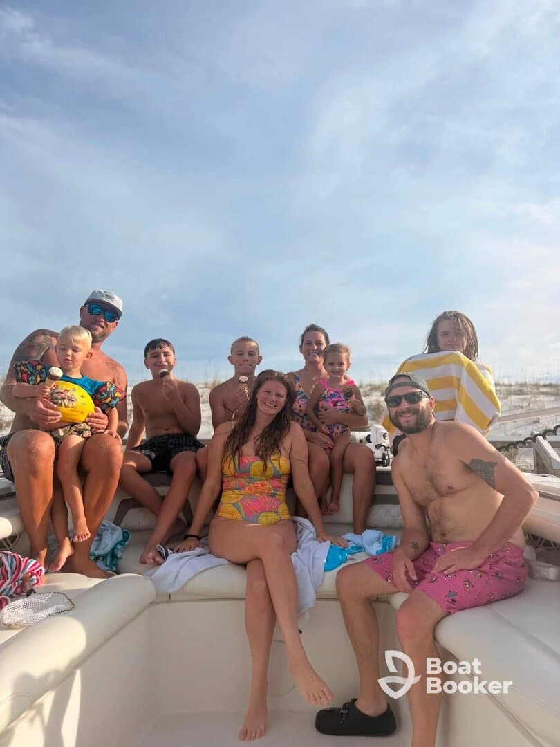 A joyful family gathers on a boat, enjoying a fun day in the sun with swimming and laughter — perfect for creating lasting memories on the water.