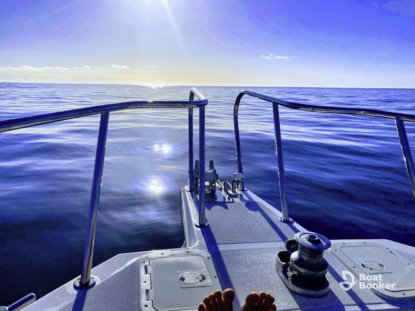 A serene view from the front of a boat, showcasing calm waters and a bright sky — perfect for peaceful outings on the sea.