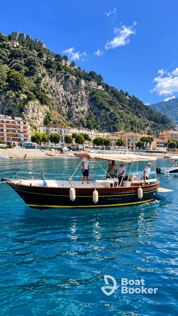 A group of people enjoy a day on the water aboard a stylish boat, surrounded by stunning coastal scenery — perfect for exploring beautiful destinations.