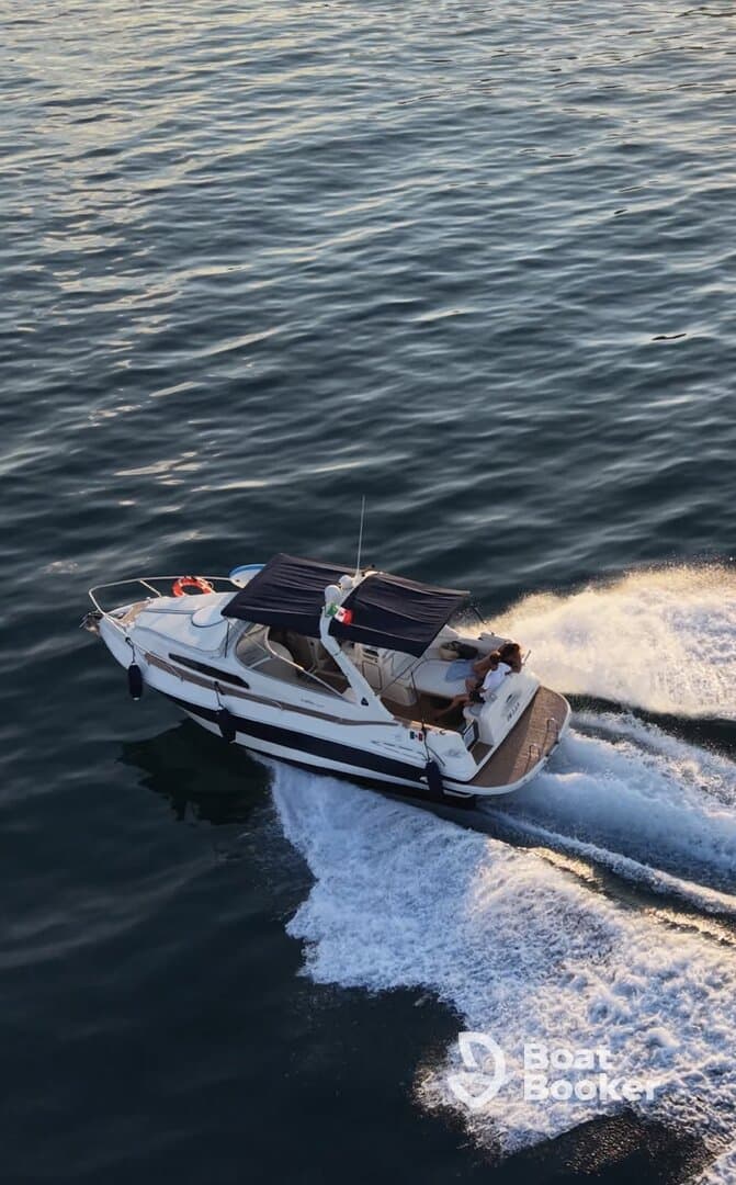 A speedboat glides through the water with guests onboard, showcasing the thrill of a day on the water.