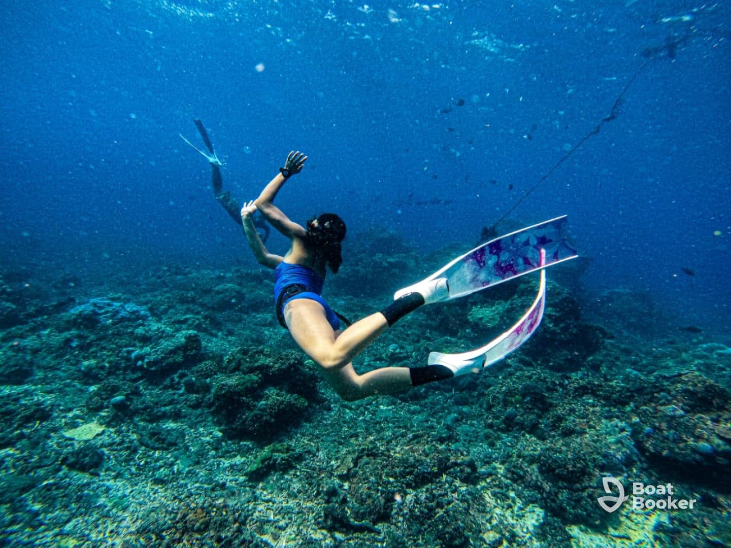 A snorkeler explores vibrant coral reefs underwater, showcasing the beauty of marine life and adventure in the ocean.