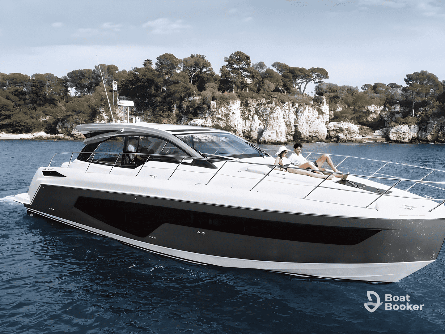 A couple enjoys sunbathing on the deck of a sleek yacht, surrounded by stunning coastal scenery — perfect for romantic getaways or leisurely days on the water.