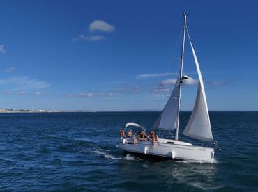 Friends sailing on a sunny blue sea