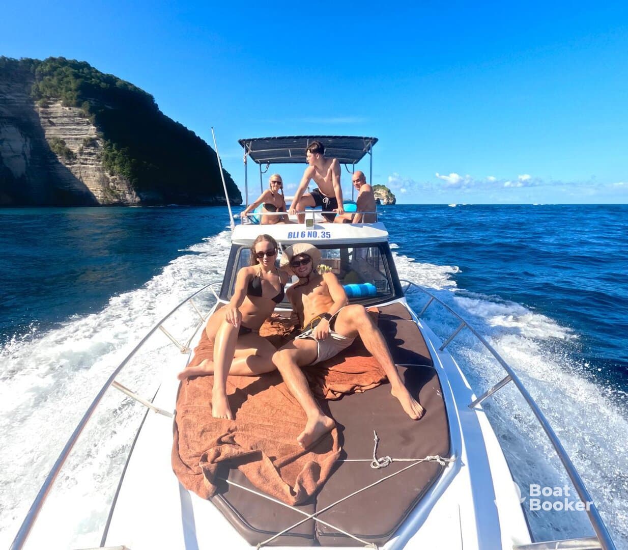 A lively group enjoys a sunny day on a boat, capturing fun moments and celebrating together on the water.
