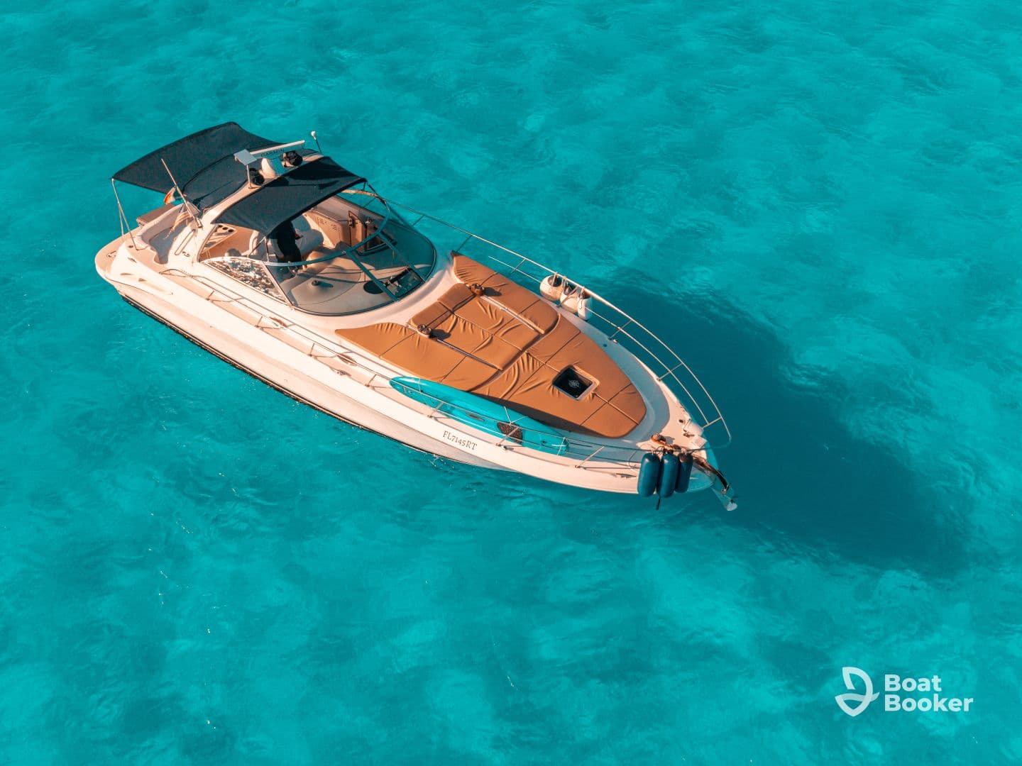 A stunning aerial view of a sleek yacht cruising through crystal-clear turquoise waters, perfect for luxurious outings and island adventures.