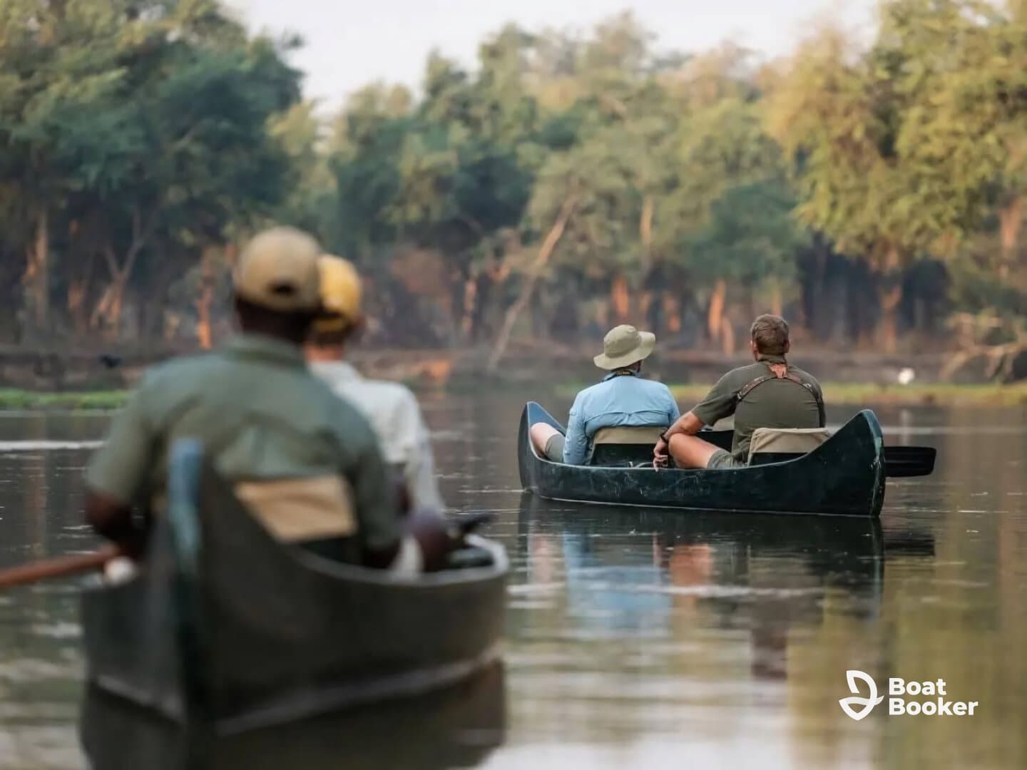 A group of adventurers enjoys a serene canoeing experience on a tranquil river, surrounded by lush greenery — perfect for nature exploration and outdoor activities.