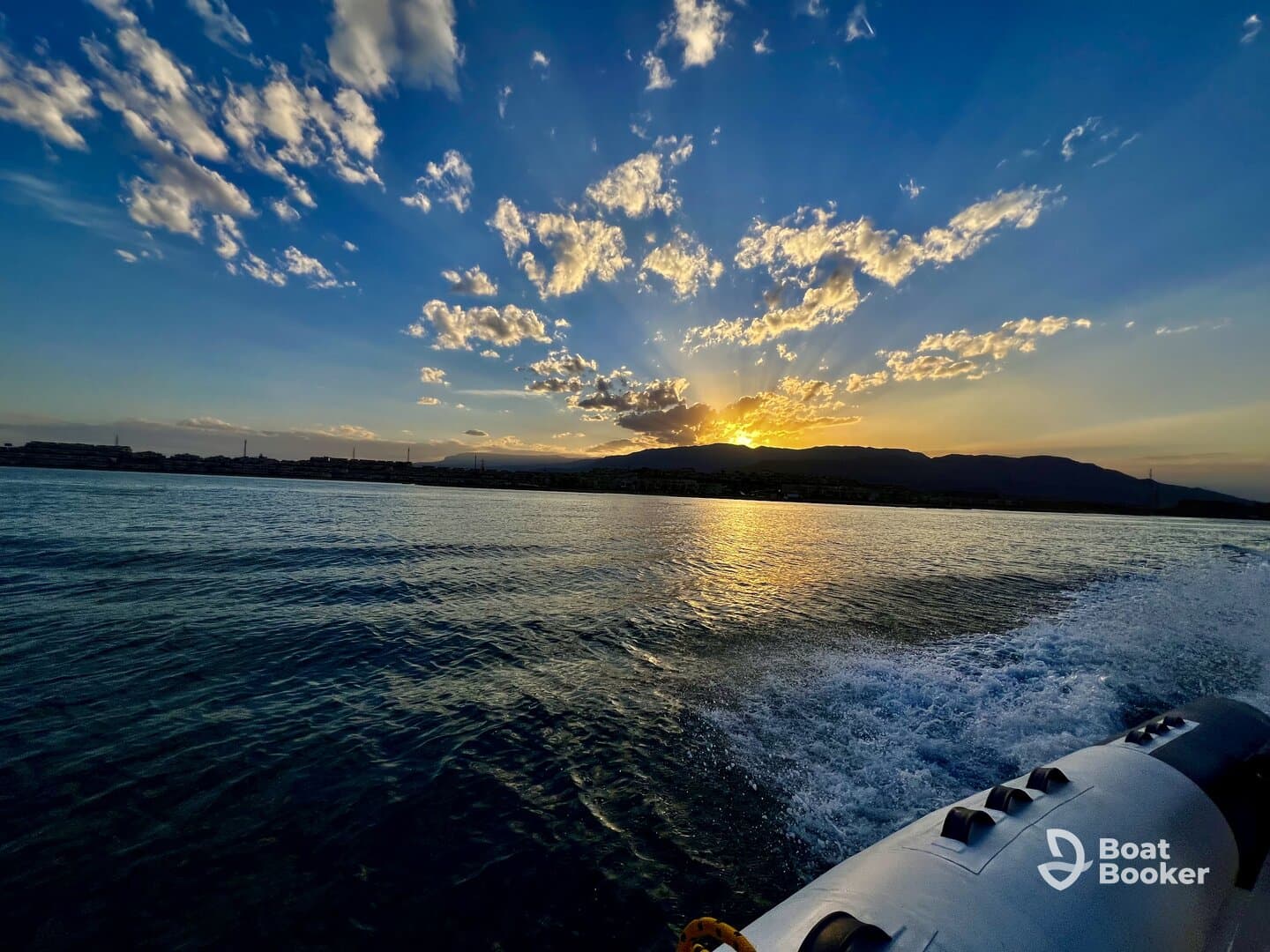 A stunning sunset view from a boat, showcasing the vibrant colors reflecting on the water — perfect for serene evening cruises.