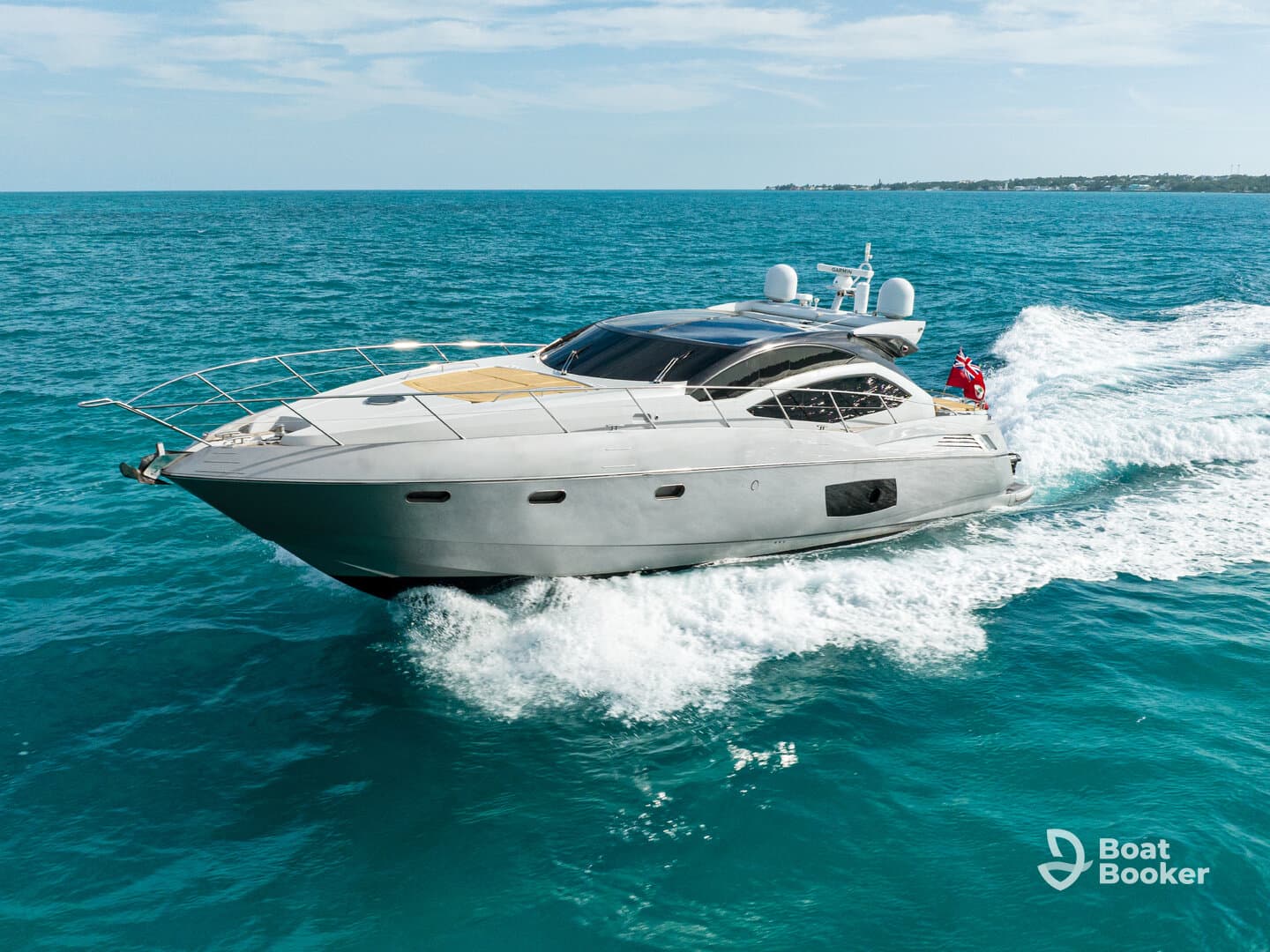 A stunning aerial view of a sleek yacht cruising through vibrant turquoise waters, showcasing its elegant design and powerful performance.