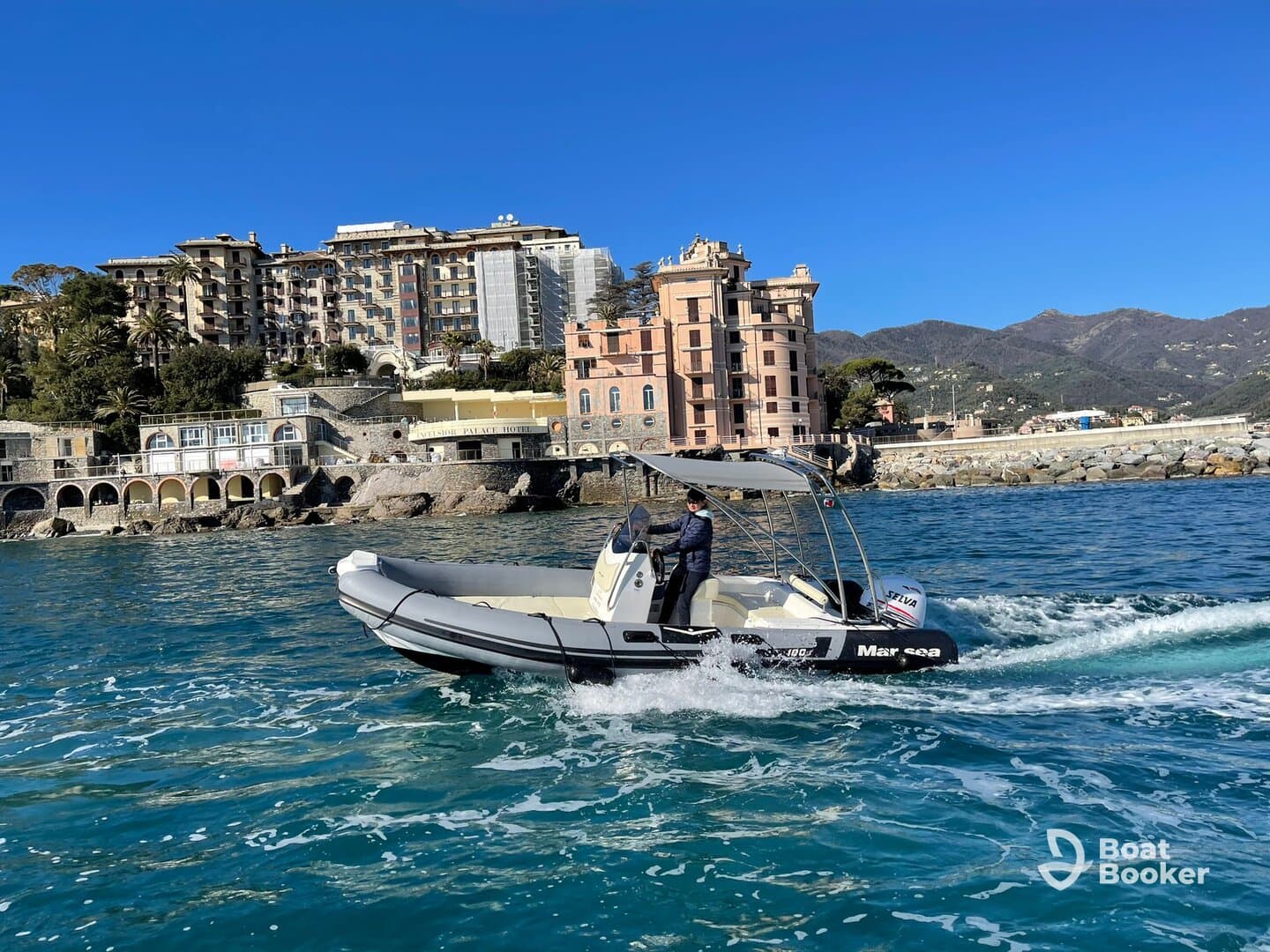 A sleek boat navigates the vibrant waters alongside a picturesque coastline, showcasing the stunning architecture of the city in the background.