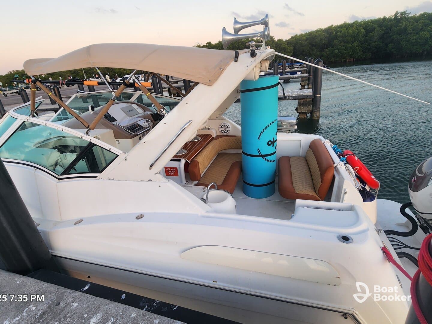 A cozy interior view of a boat showcasing comfortable seating and helm area, perfect for relaxing while cruising on the water.