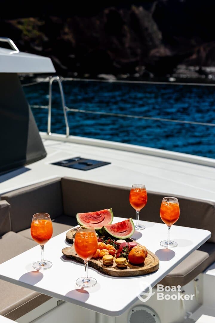 A beautifully arranged platter of fresh fruit and cocktails on a yacht, perfect for enjoying a luxurious day on the water.