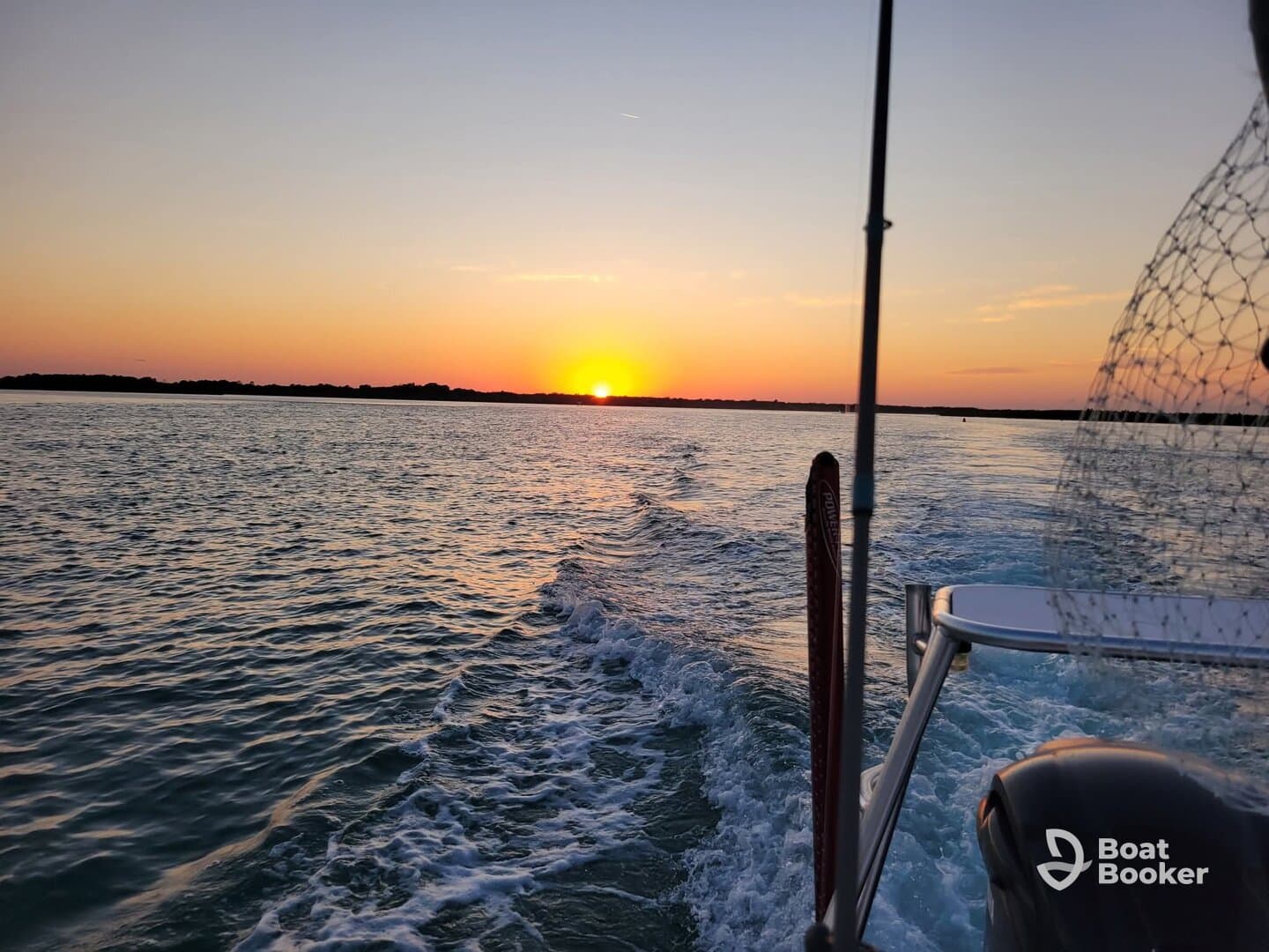 A stunning sunset view from a boat, showcasing the tranquil waters and vibrant colors of the sky — perfect for evening cruises.