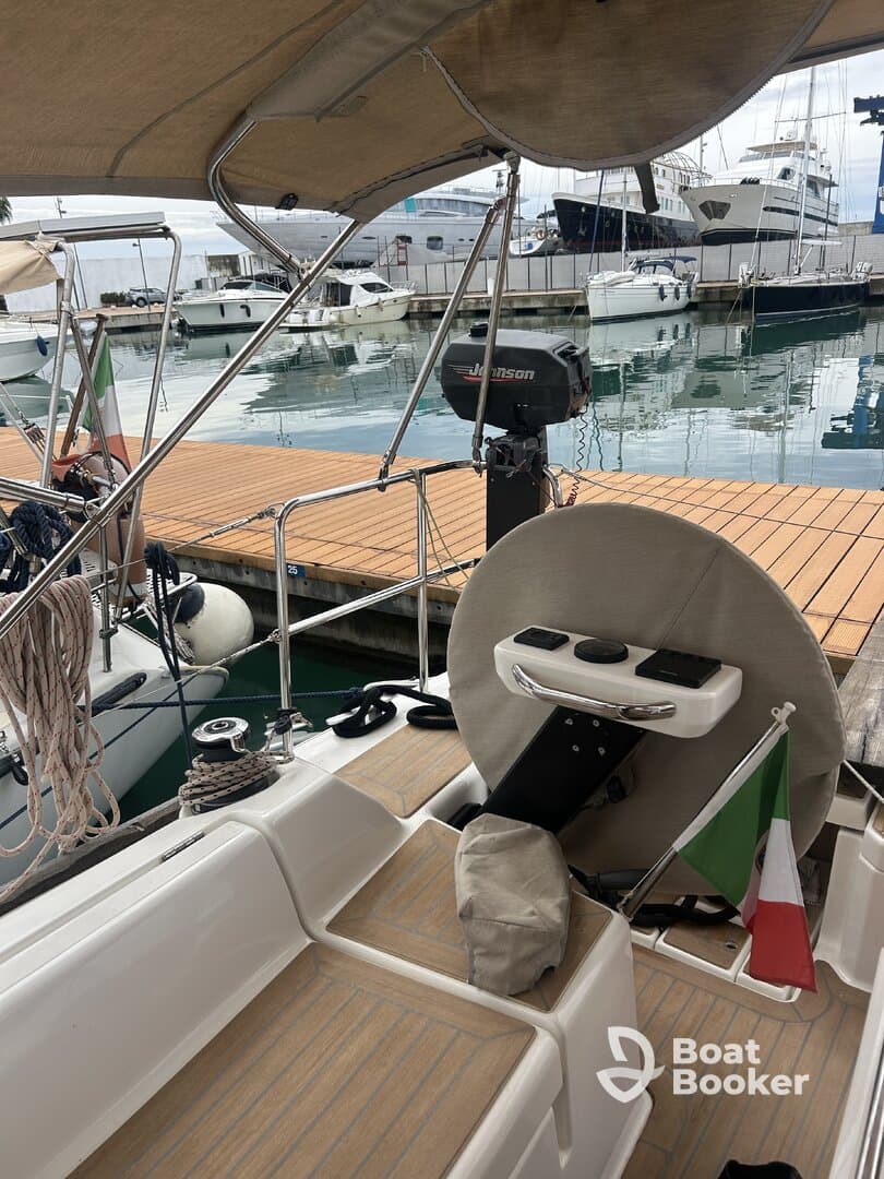 A detailed view of the helm area inside a boat, showcasing the steering console and seating, perfect for navigating the waters.