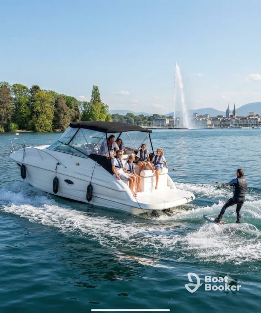 A lively group enjoys a day on the water, with some relaxing on the boat while others engage in wakeboarding — a perfect blend of fun and adventure.