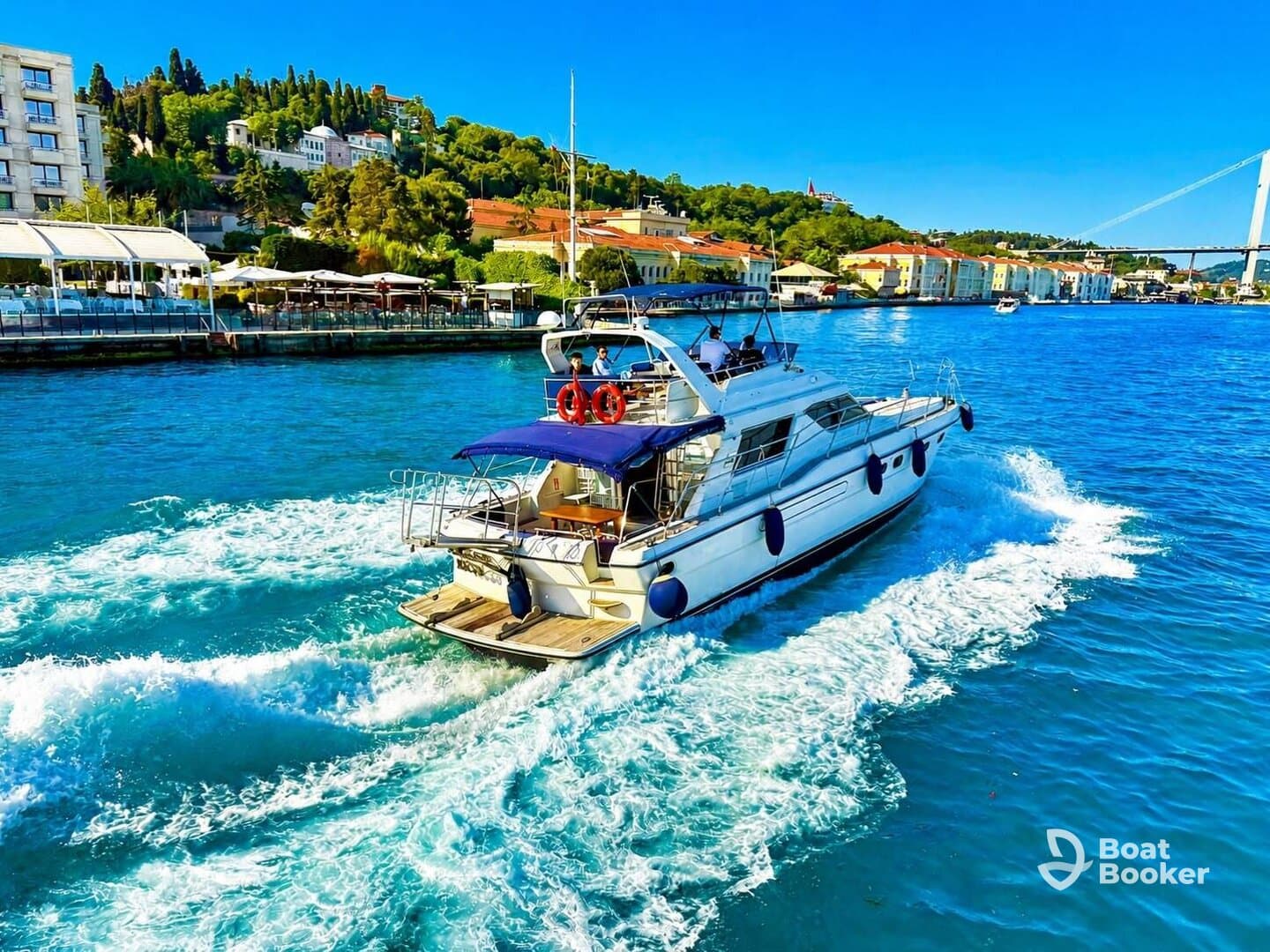 A stunning yacht navigates through crystal-clear waters, showcasing its sleek design and vibrant surroundings — perfect for luxury cruising.