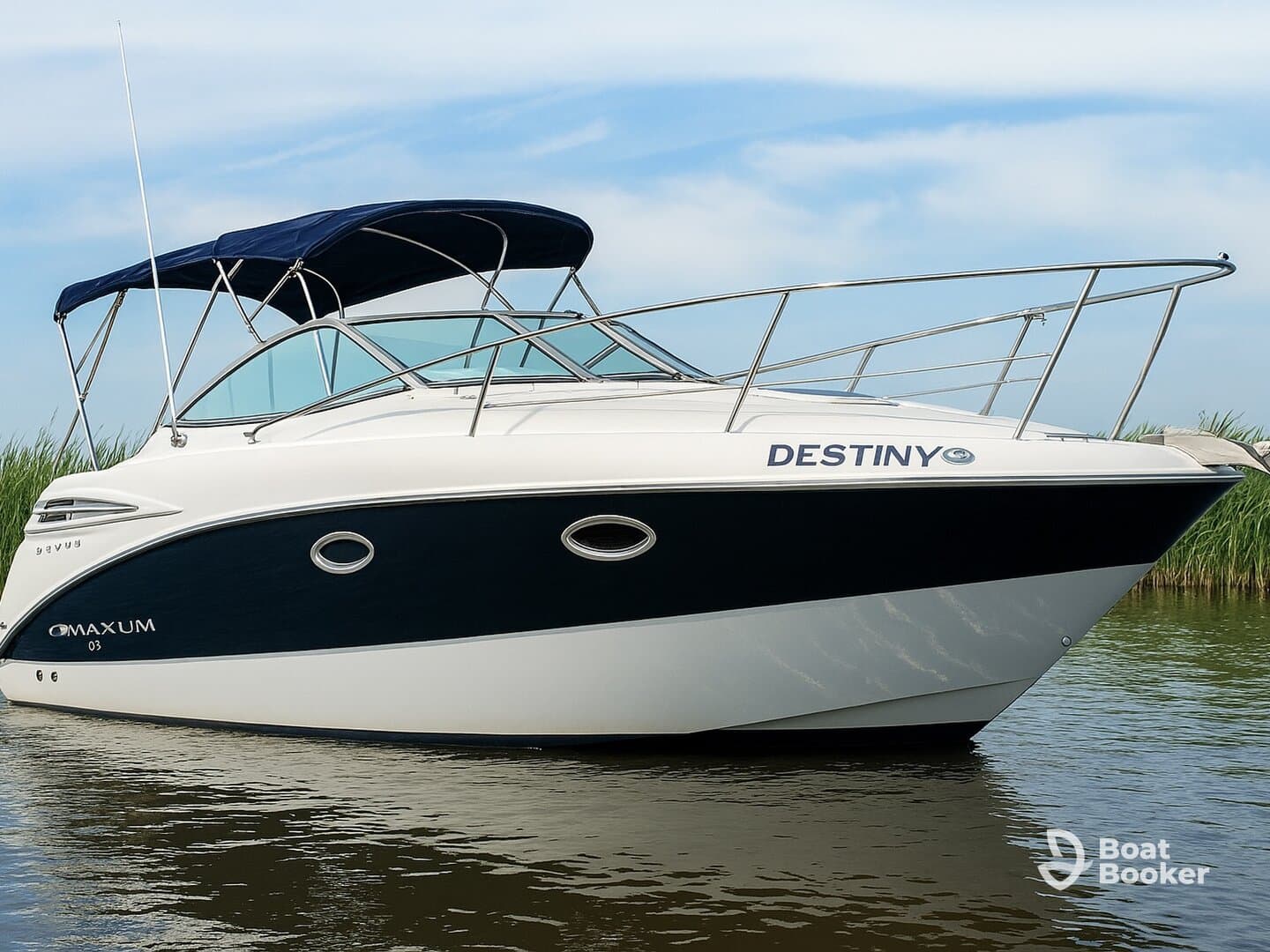 A sleek view of the 'Destiny' boat, showcasing its elegant design and structure while docked in calm waters, perfect for a day of relaxation on the water.