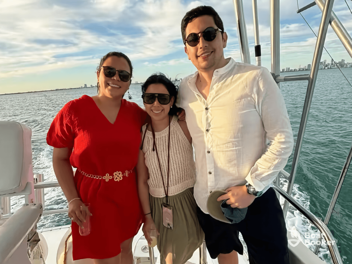 A cheerful group of friends poses together on a boat, enjoying a beautiful day on the water — perfect for memorable outings and celebrations.
