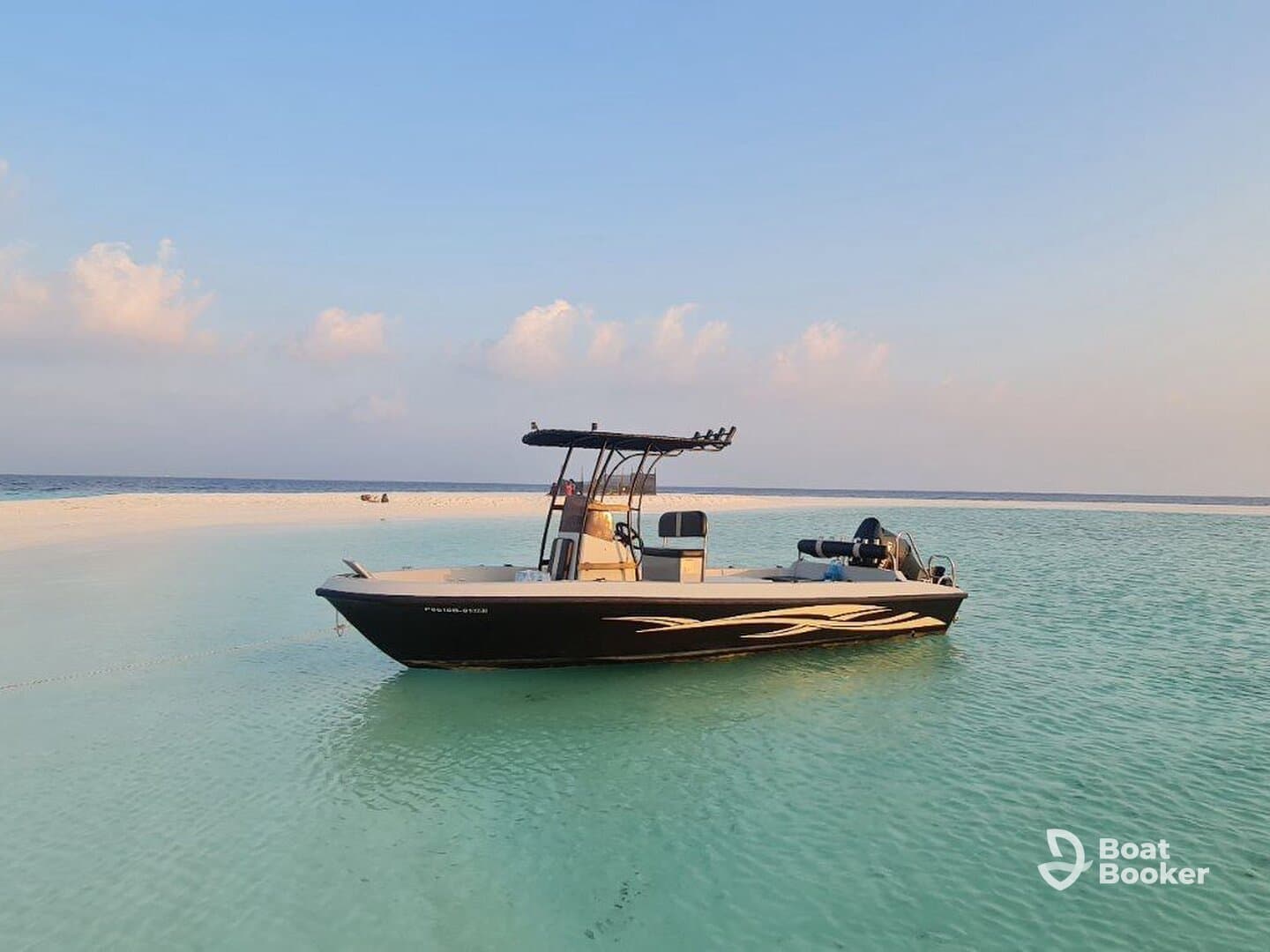 A sleek speedboat anchored in crystal-clear waters, surrounded by a pristine sandbar — perfect for a day of relaxation and adventure on the water.