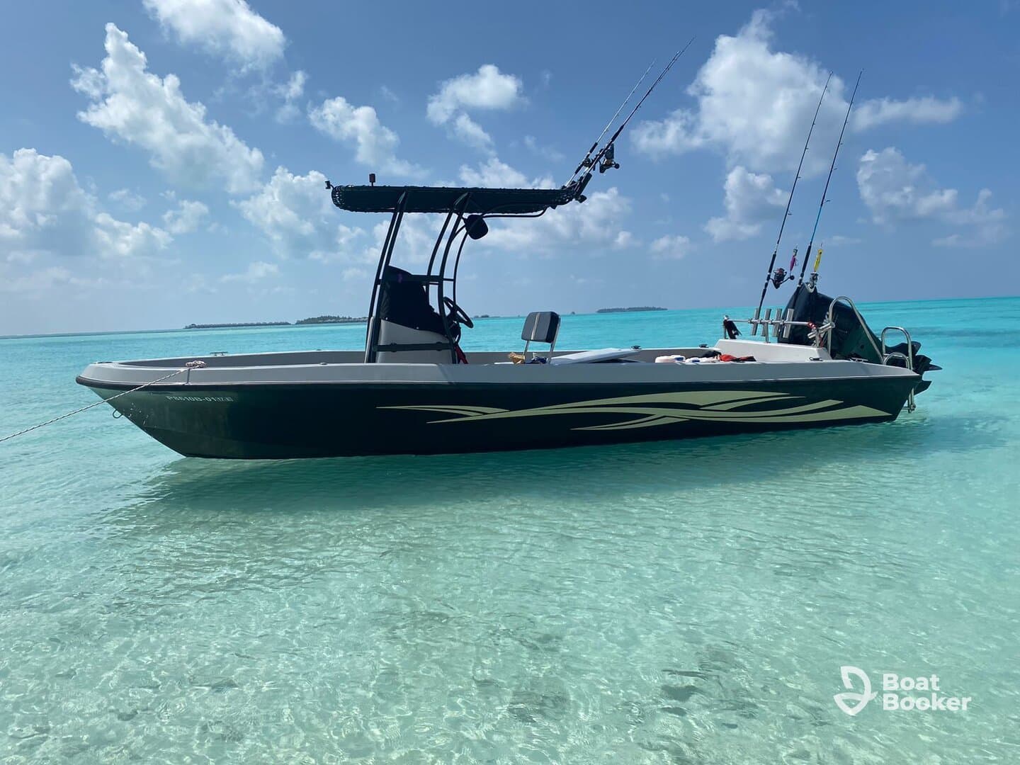 A sleek speedboat anchored in crystal-clear turquoise waters, showcasing its design against a stunning tropical backdrop.