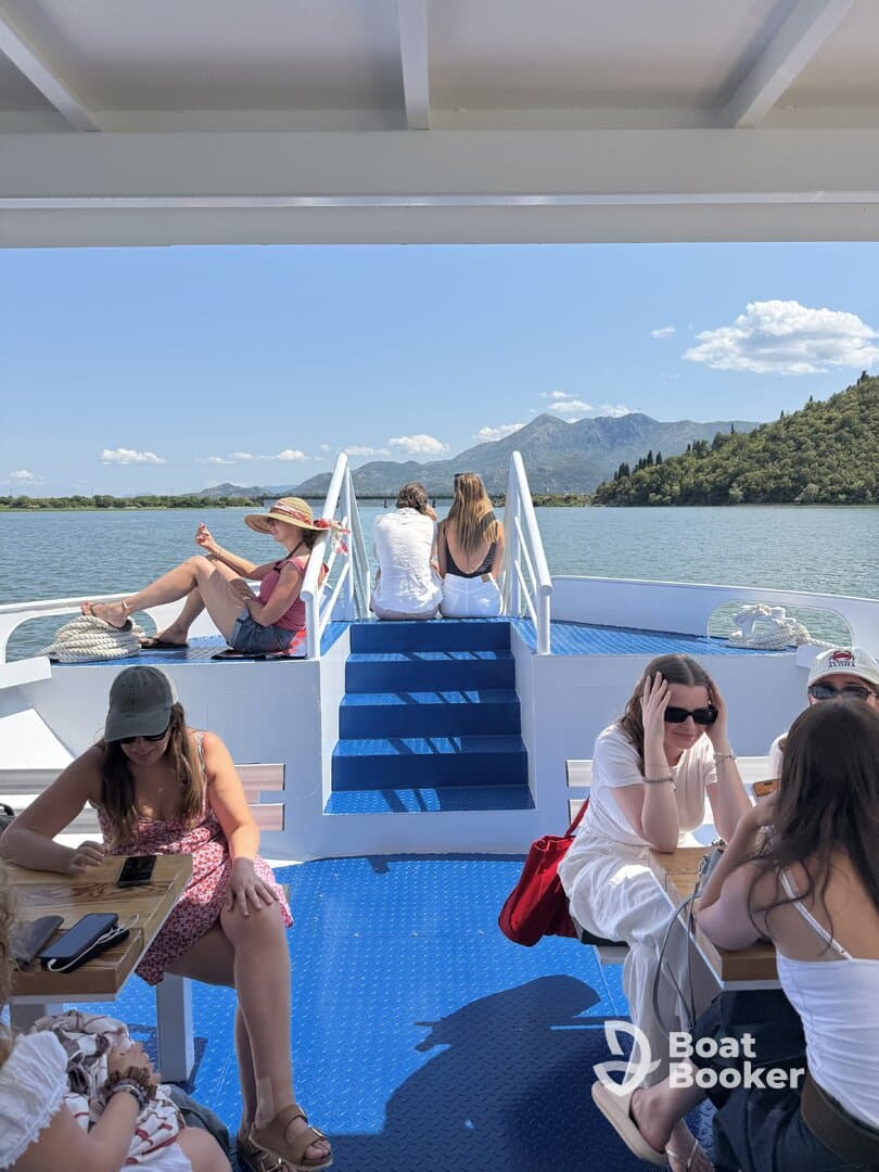 A lively group enjoys a relaxing day on a boat, taking in beautiful scenery and creating memories on the water.