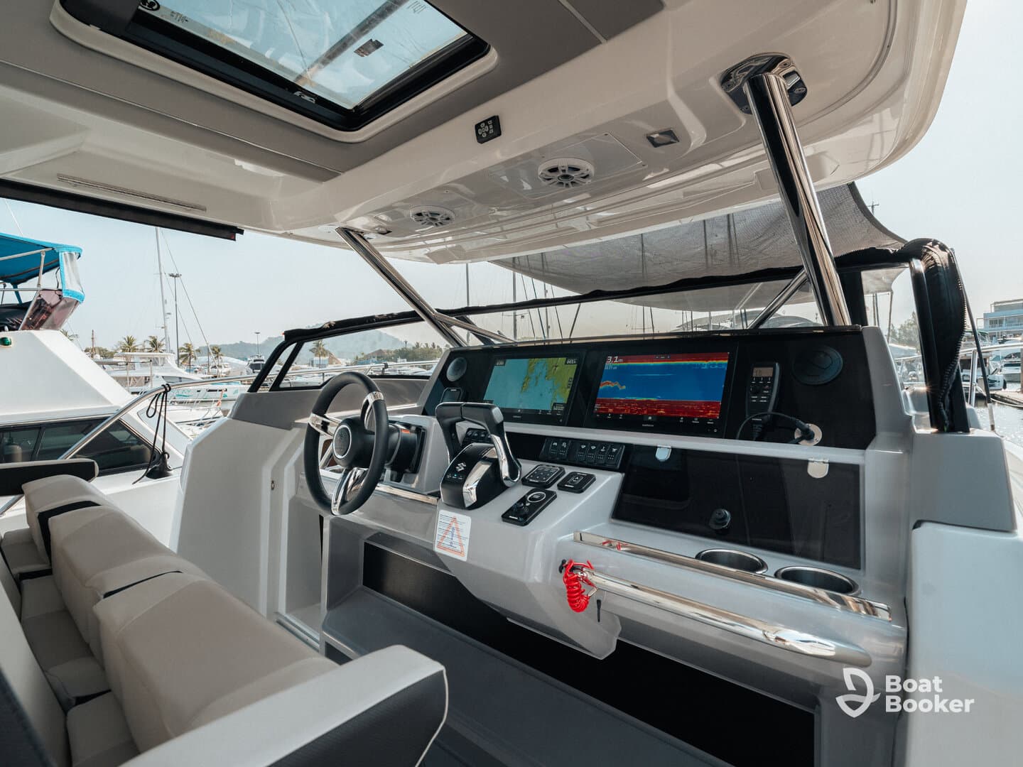 A sleek and modern helm interior showcasing the control console and seating area, perfect for navigating the open waters in style.
