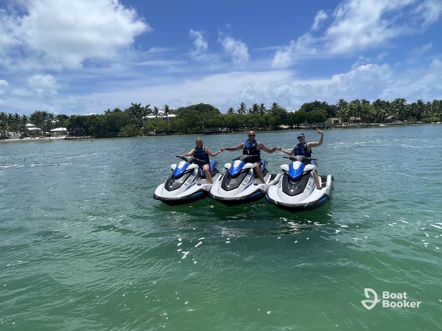 A group of friends enjoys a thrilling day on jet skis, showcasing the excitement of water activities in a beautiful tropical setting.