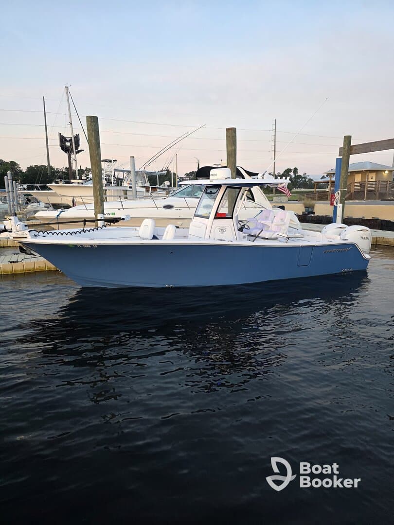 A sleek center console boat docked at the marina, showcasing its stylish design and readiness for a day on the water.