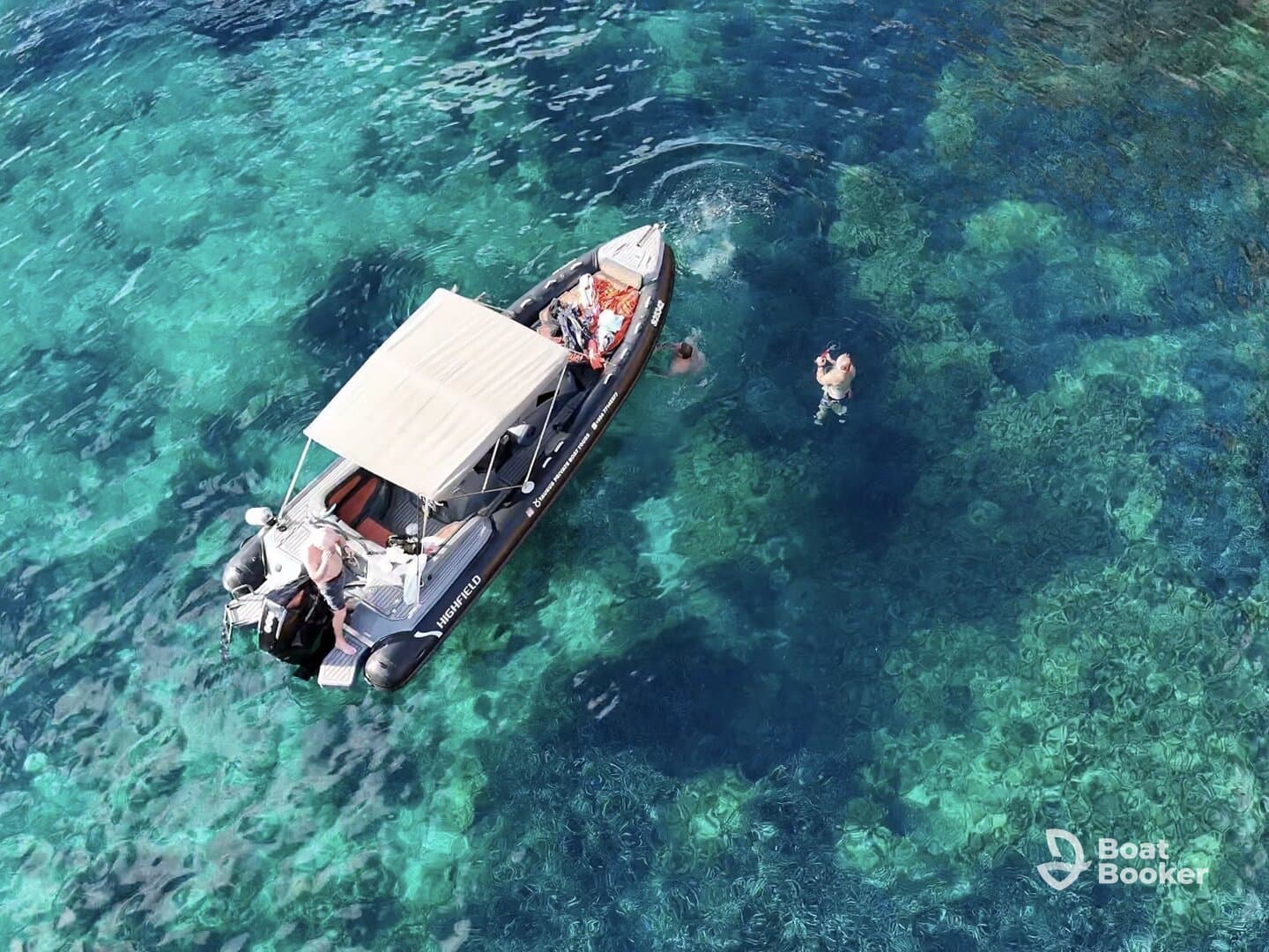 A group enjoys a snorkeling adventure in crystal-clear waters, with a boat anchored nearby, showcasing the perfect blend of fun and exploration.