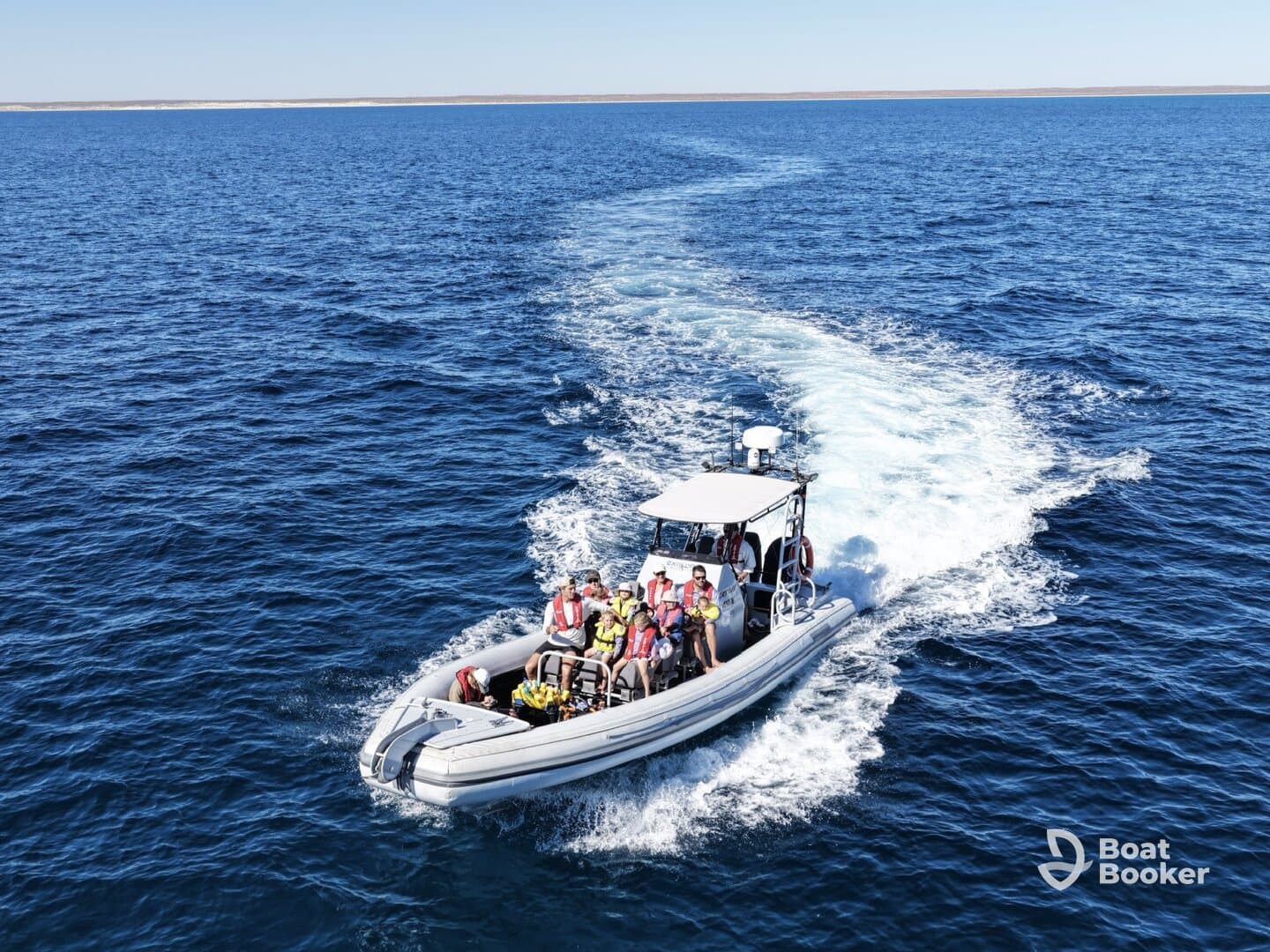 A lively group enjoys a thrilling ride on a speedboat, showcasing the excitement of on-water adventures in clear blue waters.