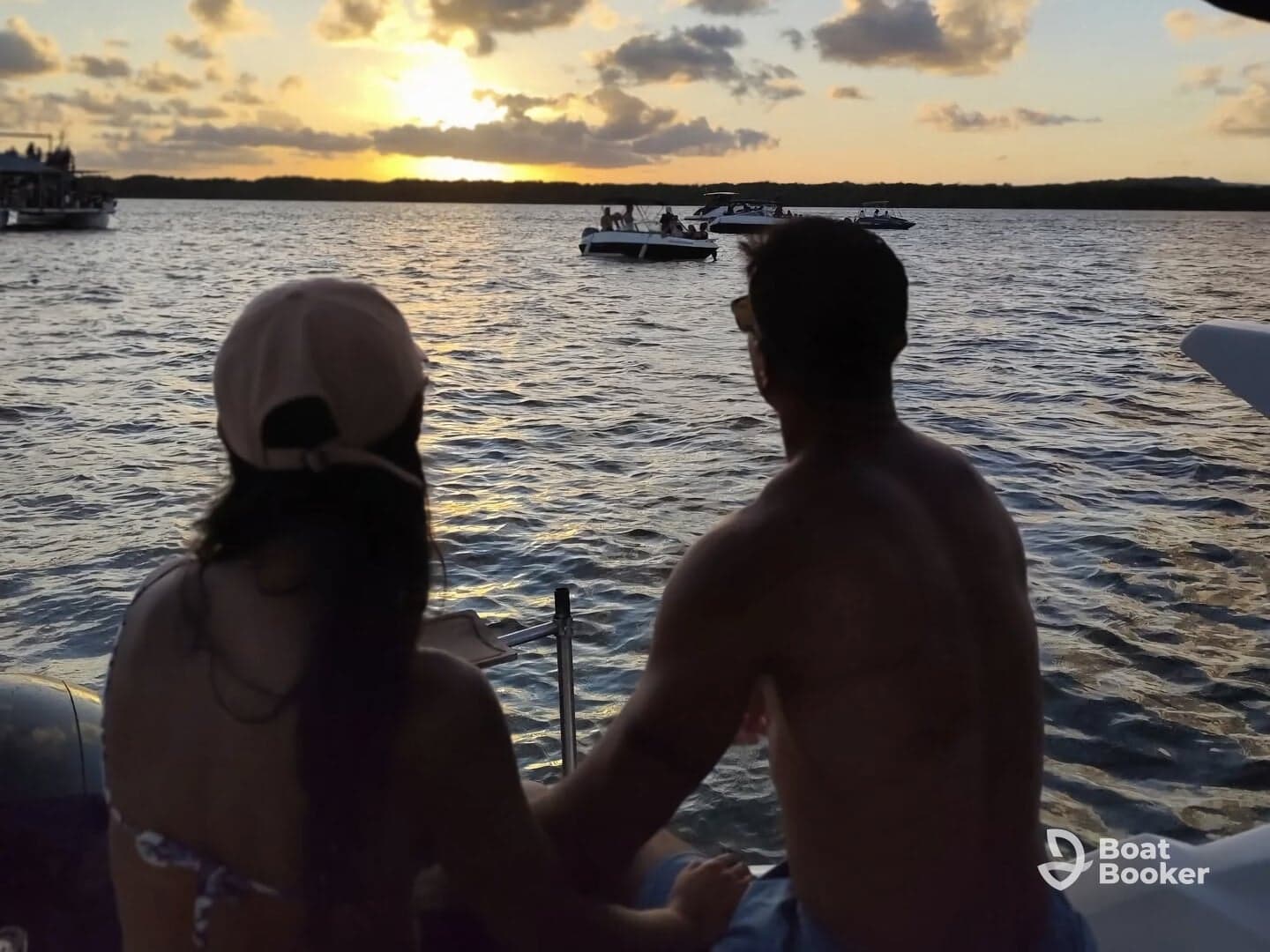 A couple enjoys a romantic sunset view on the water, creating the perfect backdrop for memorable moments during a boating adventure.