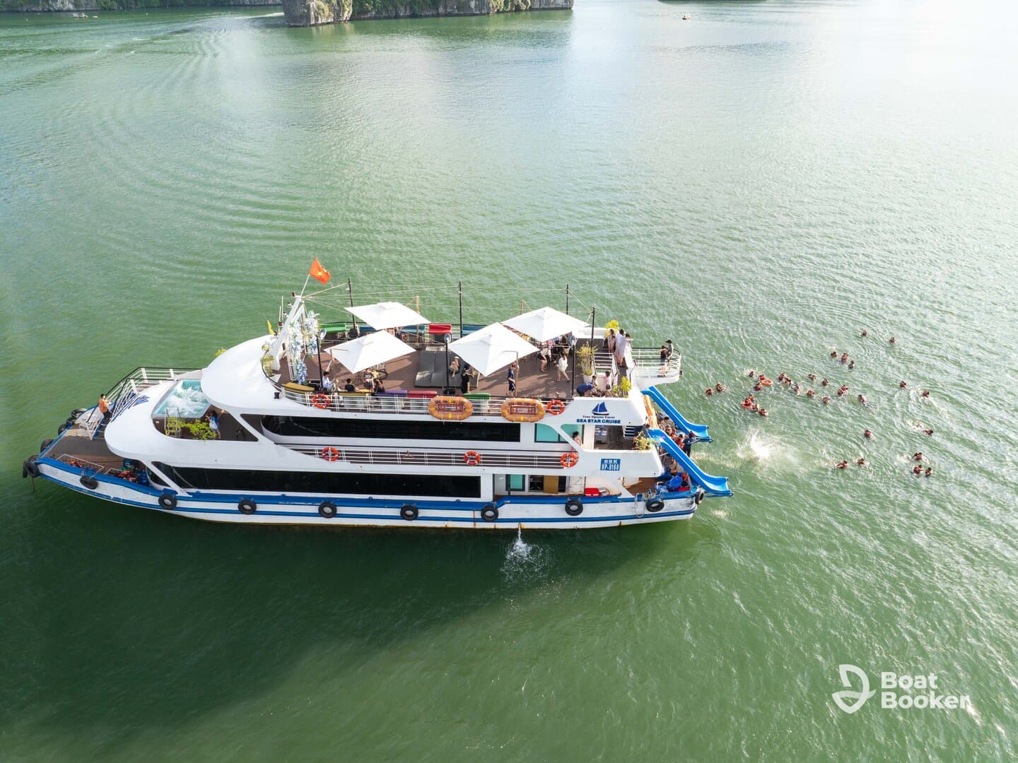 A lively scene featuring a group of swimmers enjoying water activities around a spacious boat, showcasing the fun and excitement of a day on the water.