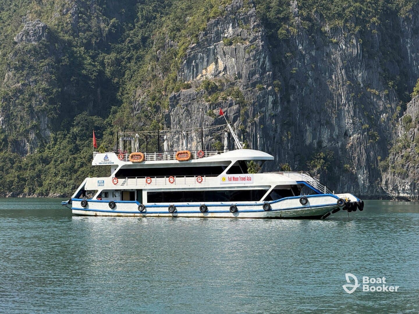 A beautiful yacht navigates through serene waters, surrounded by stunning cliffs, perfect for exploring scenic destinations.