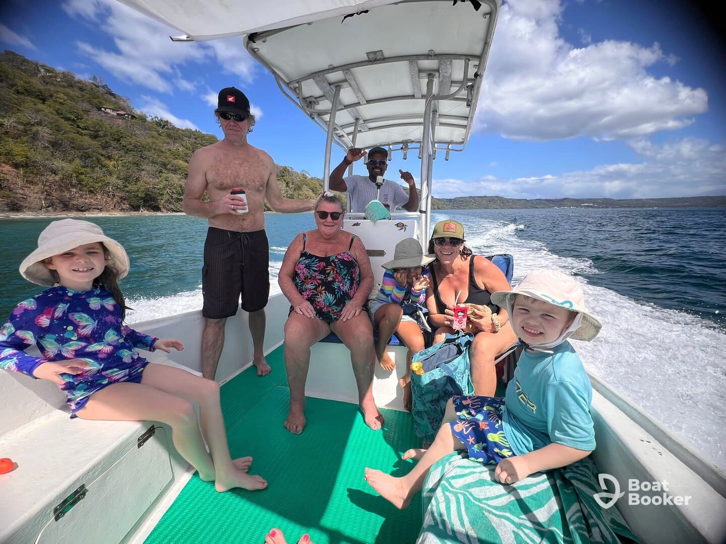 A joyful family enjoys their time aboard a boat, capturing the essence of fun and adventure on the water with children and adults alike.