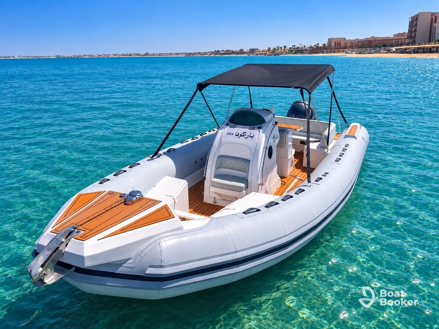 A sleek speedboat anchored in crystal-clear waters, showcasing its modern design and inviting atmosphere for a perfect day on the water.
