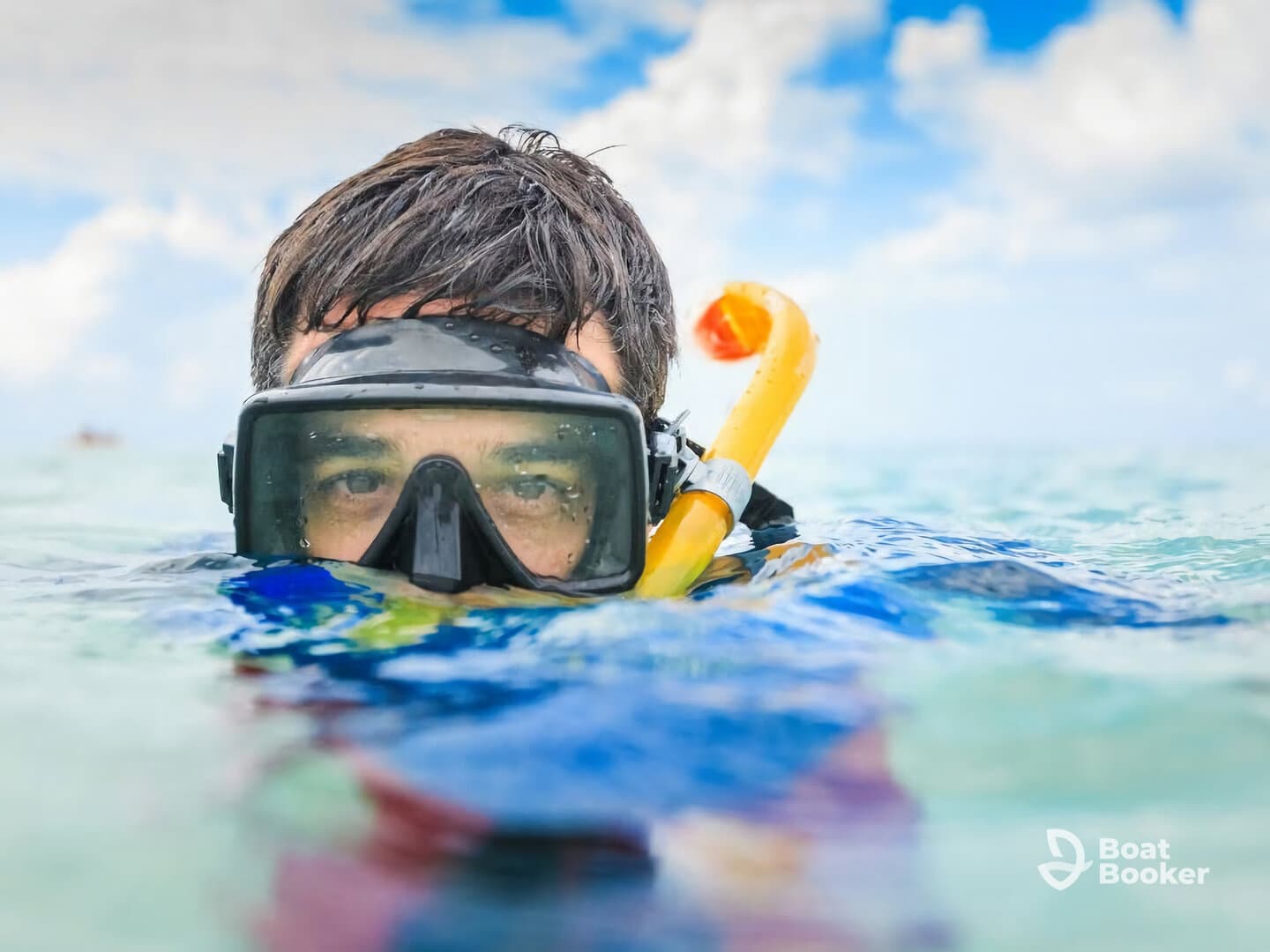 A snorkeler enjoys the clear waters, ready to explore the underwater world — a perfect moment for adventure seekers and marine enthusiasts.