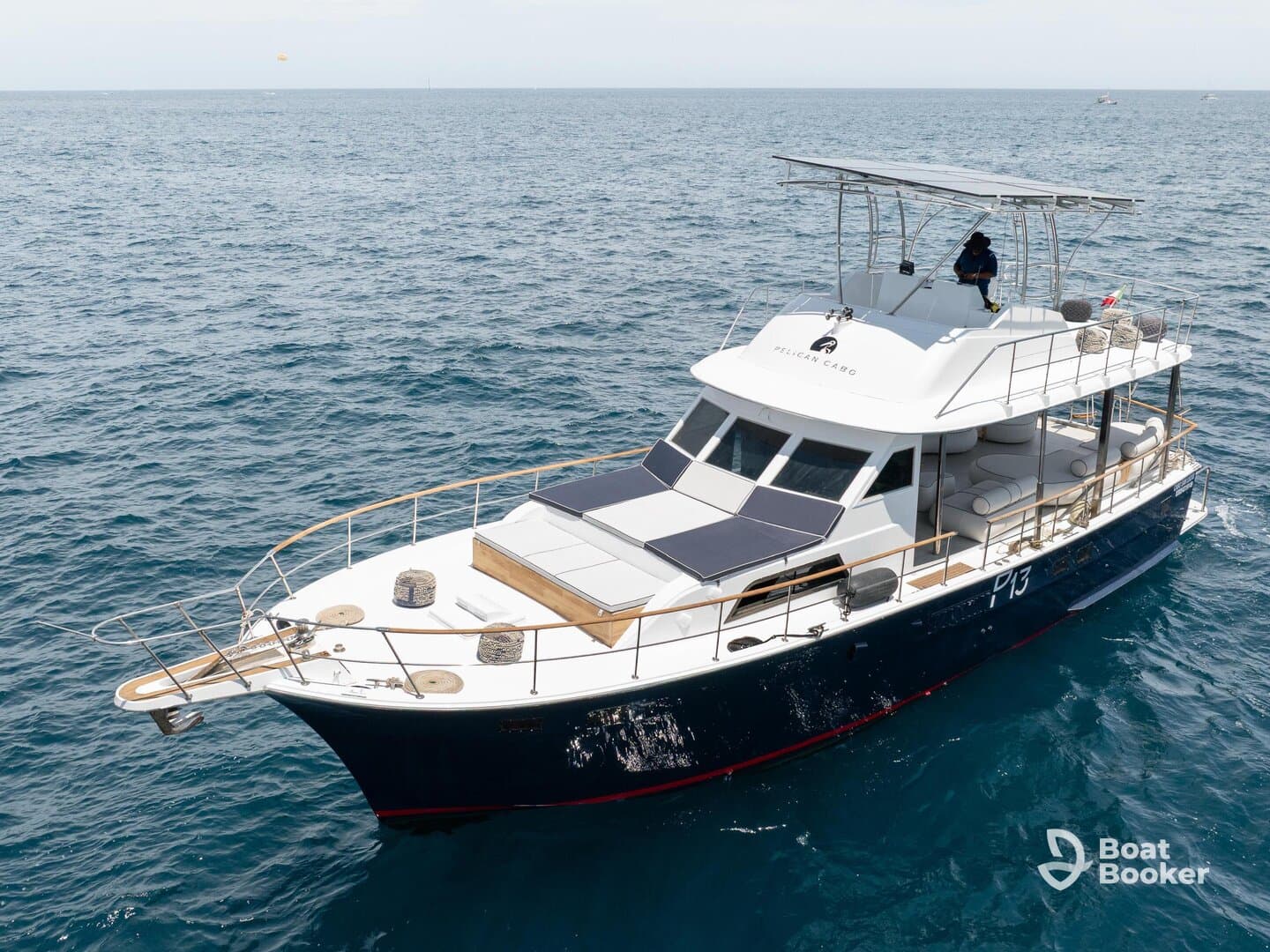 A stunning aerial view of a yacht cruising through open waters, showcasing its elegant design and spacious deck — perfect for luxury charters and ocean adventures.