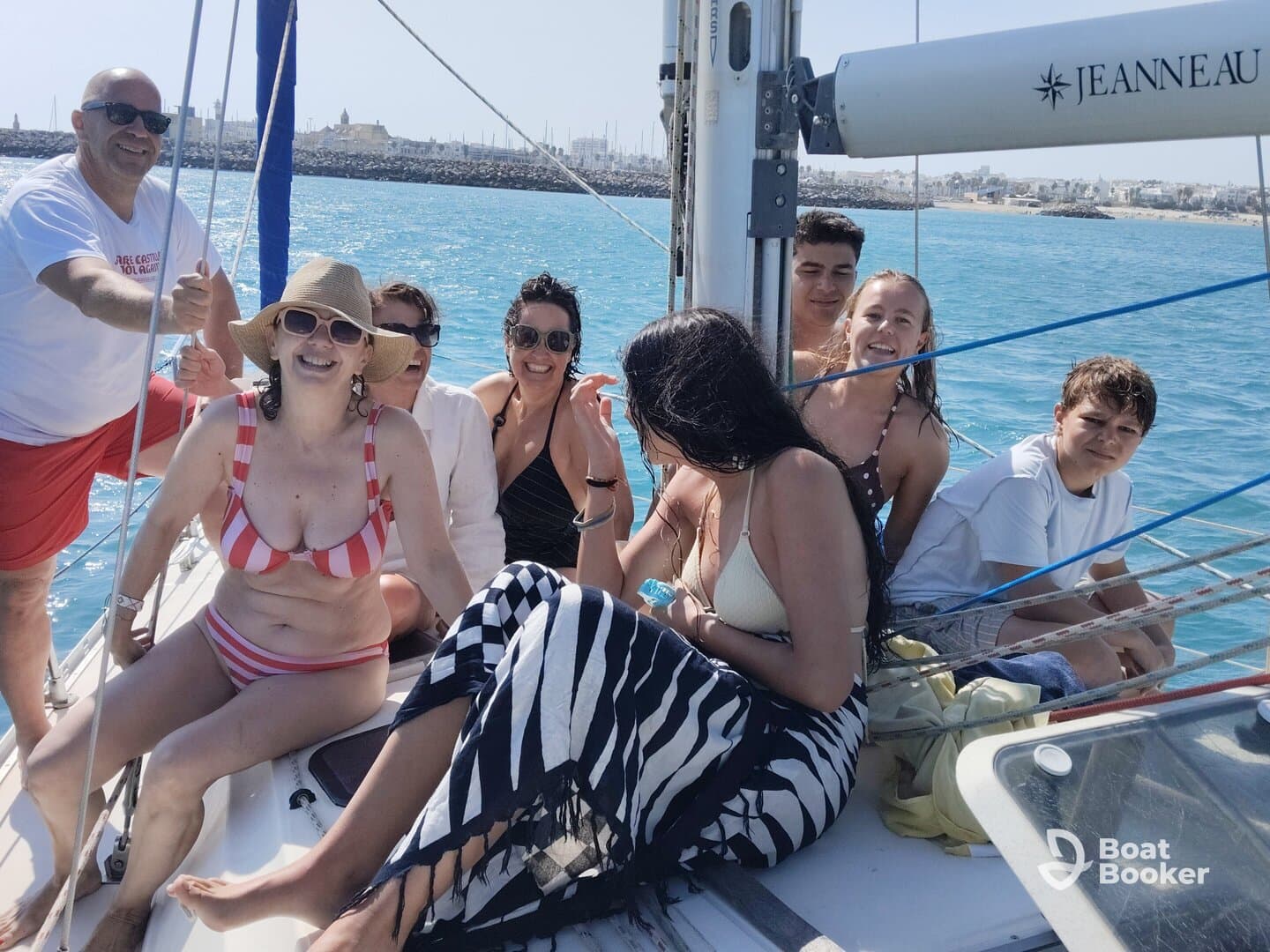 A joyful group enjoys a sailing adventure, capturing moments of laughter and fun on the water. Perfect for family outings or celebrations.
