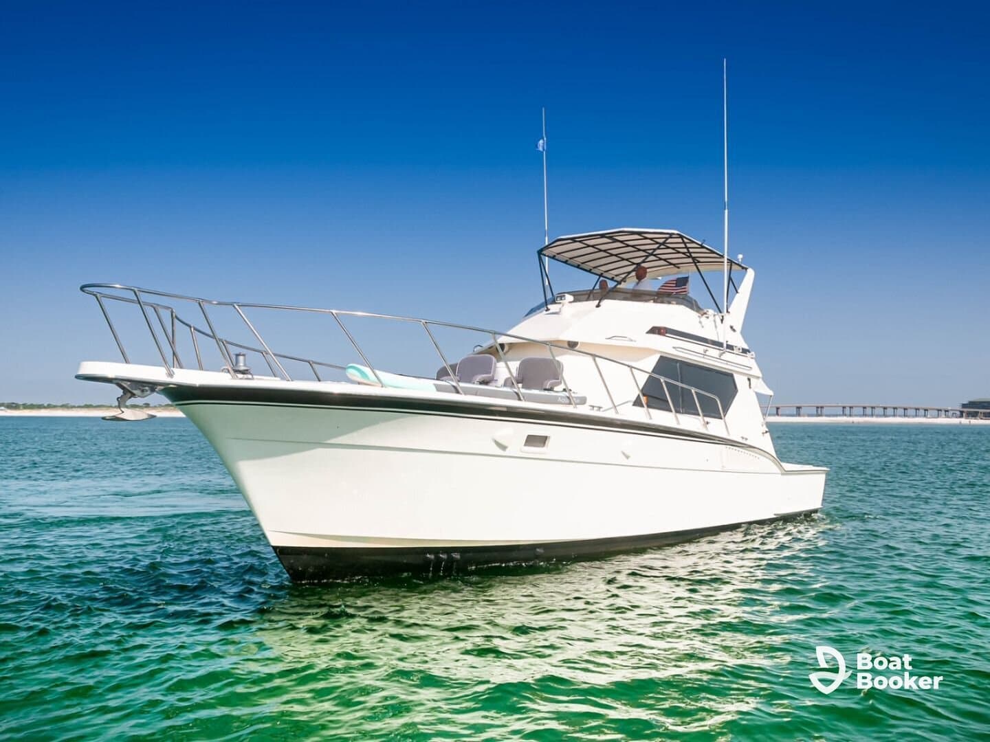 A stunning yacht cruising through clear waters, showcasing its sleek design and inviting atmosphere — perfect for luxury outings and fishing trips.