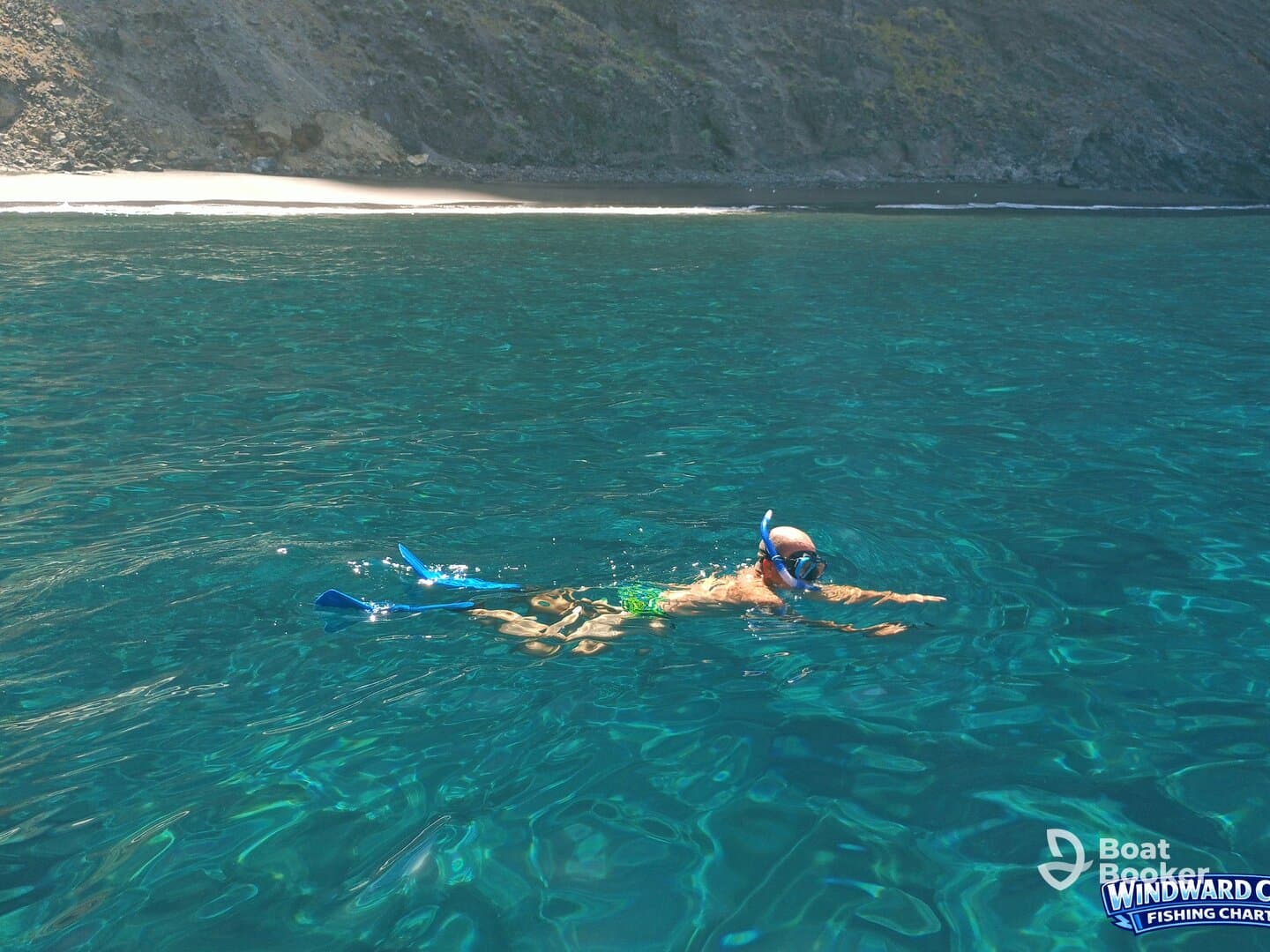 A snorkeler explores the vibrant underwater world in crystal-clear waters, showcasing the beauty of marine life and adventure on the water.