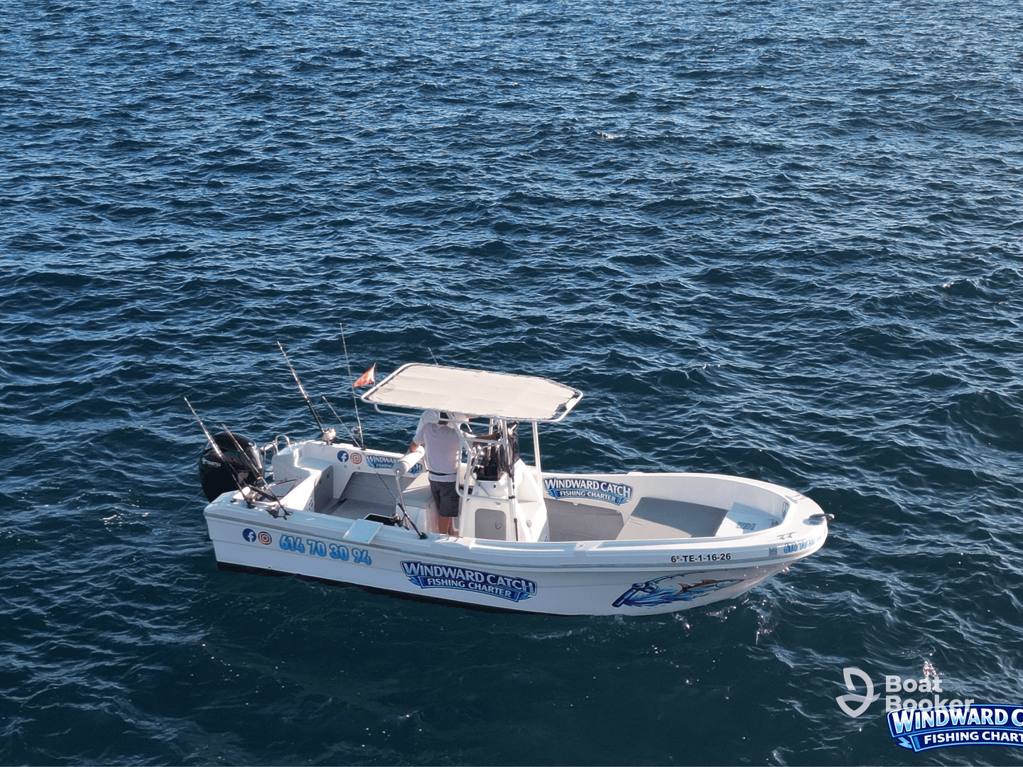 A fishing charter boat, 'Windward Catch', navigates through clear waters, showcasing its readiness for an exciting day of fishing adventures.
