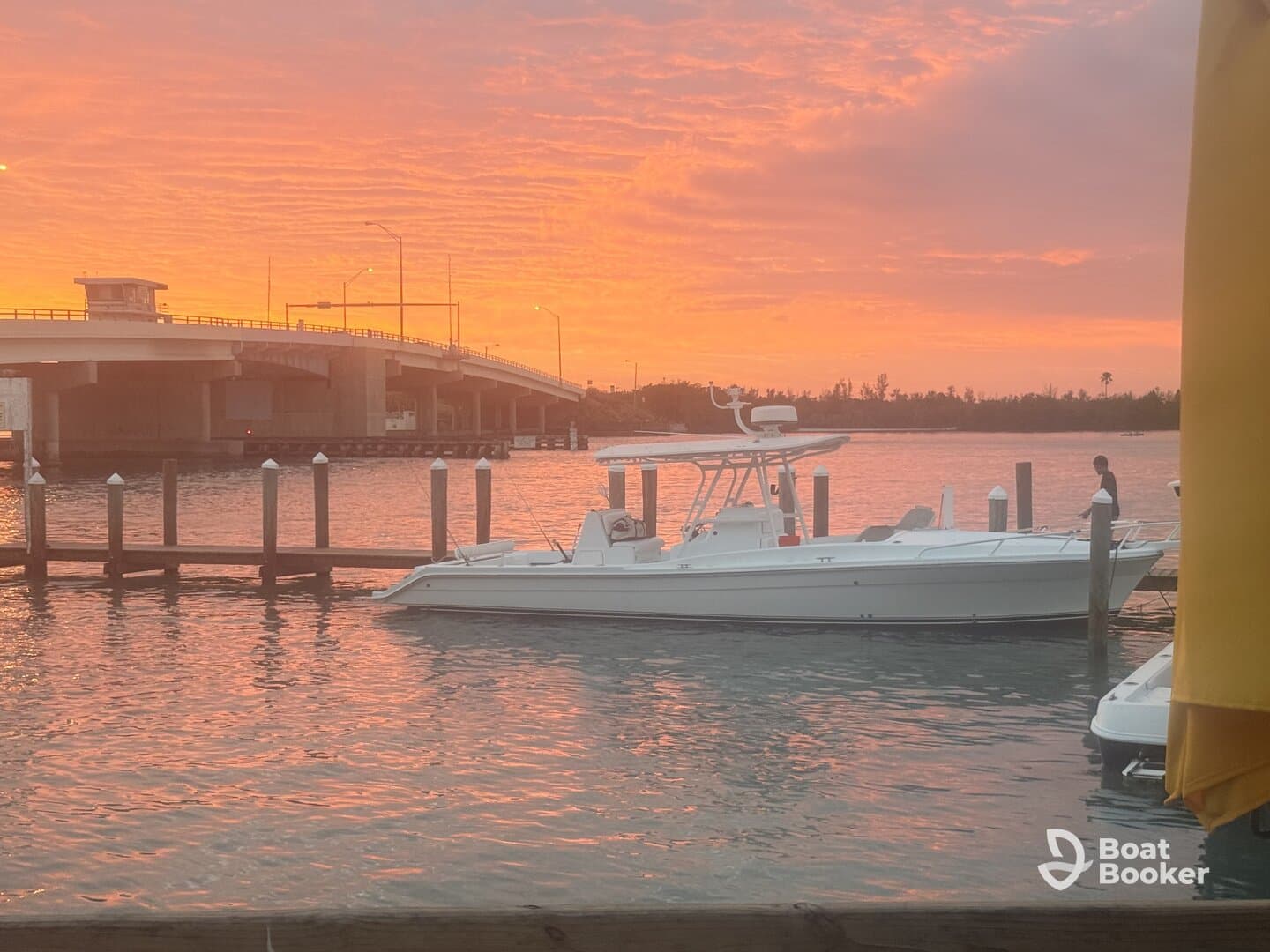 A sleek speedboat docked at sunset, with vibrant colors reflecting on the water — a picturesque scene perfect for evening outings.